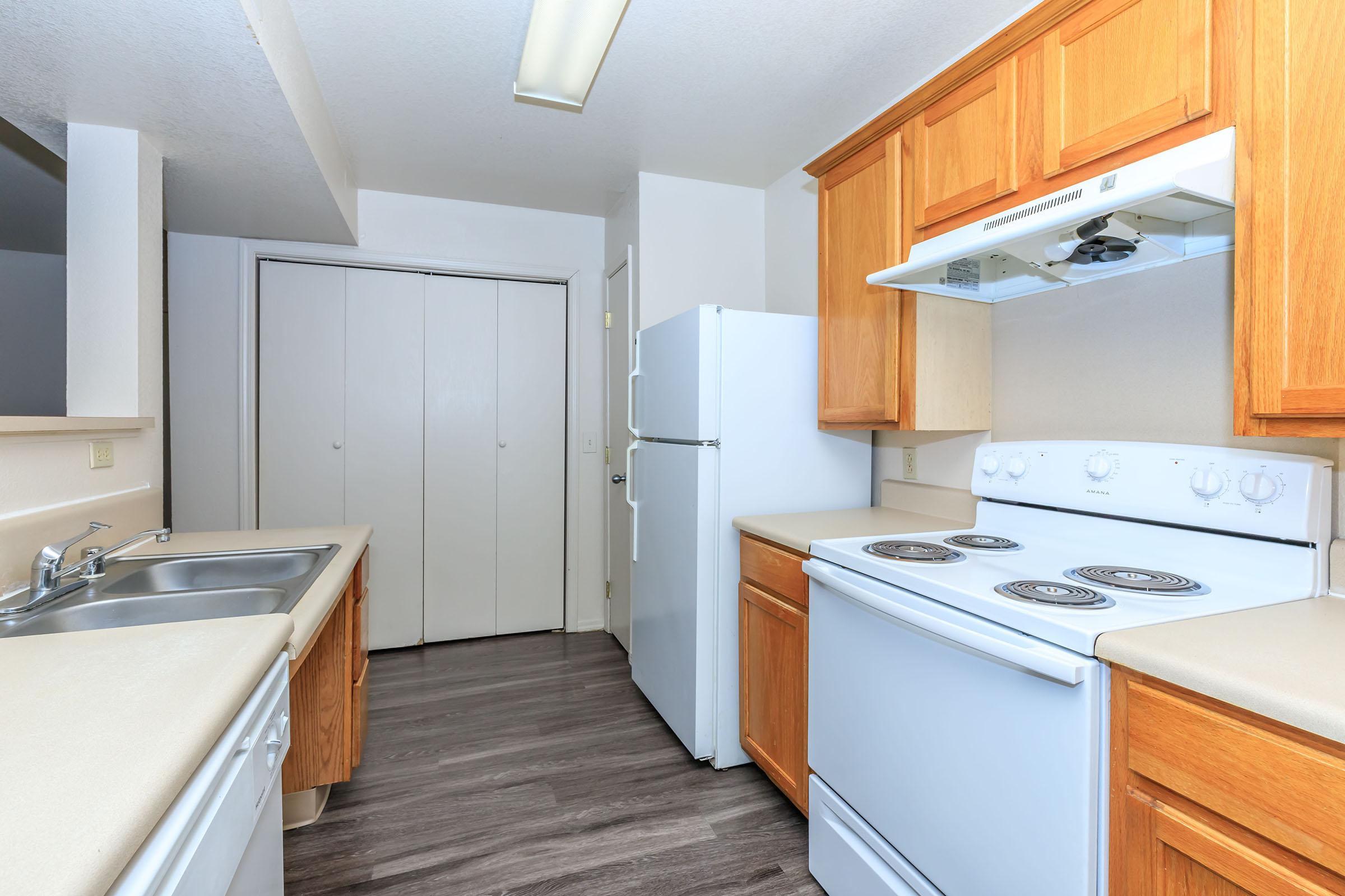 a kitchen with a stove a sink and a microwave