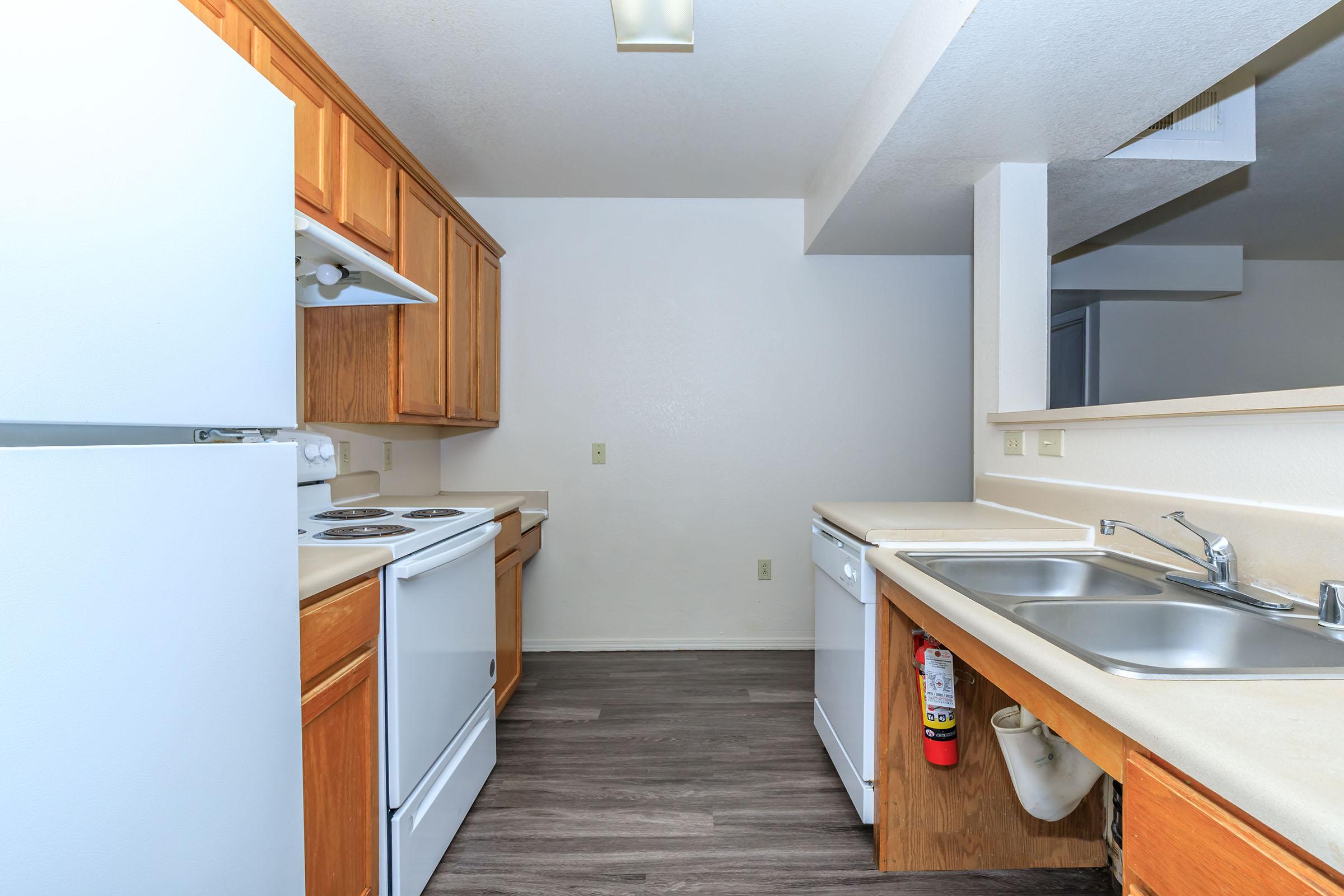 a kitchen with a sink and a refrigerator