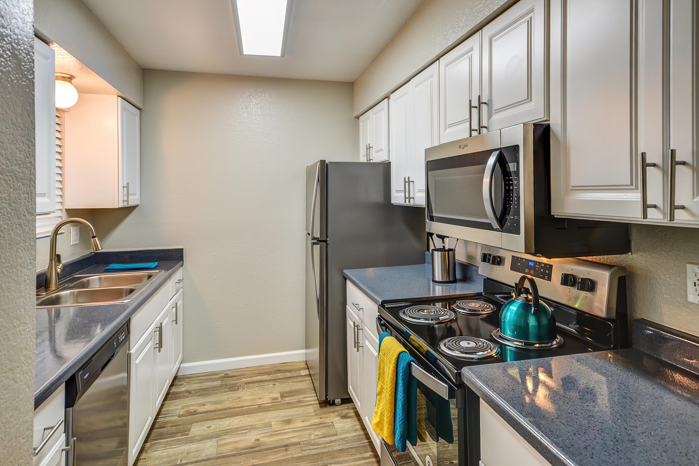 a kitchen with a sink and a refrigerator