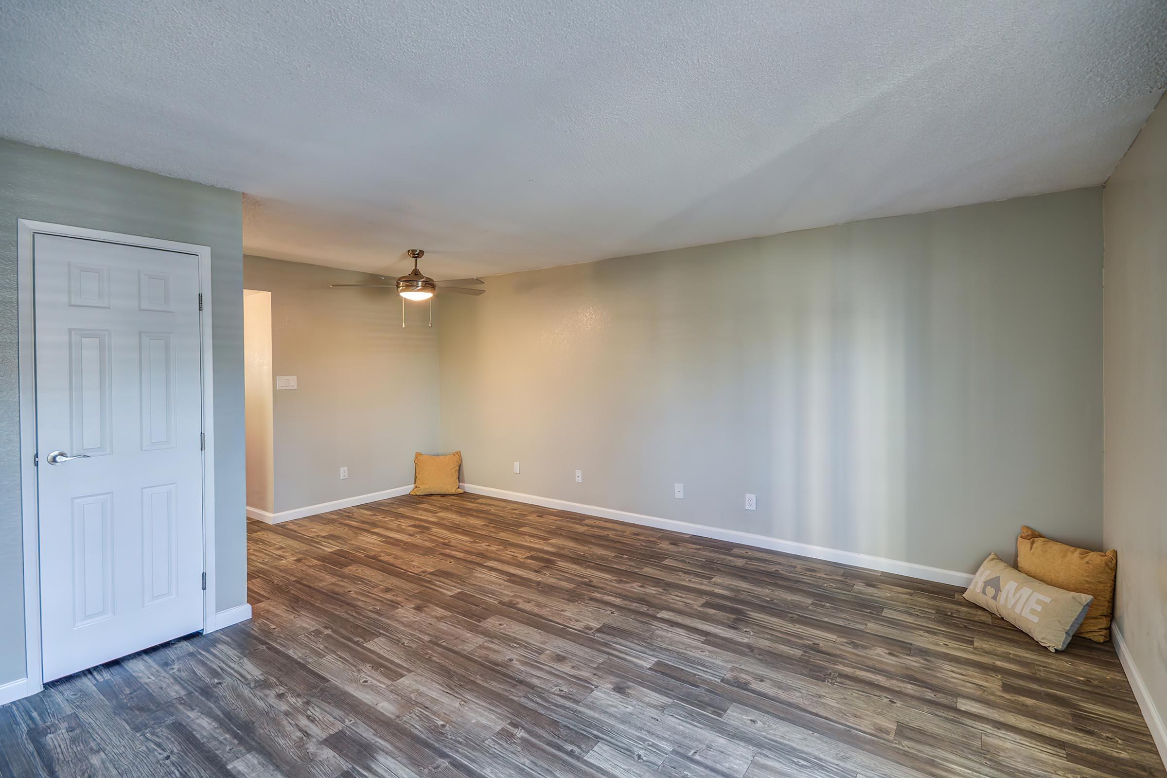 a bedroom with a wooden floor