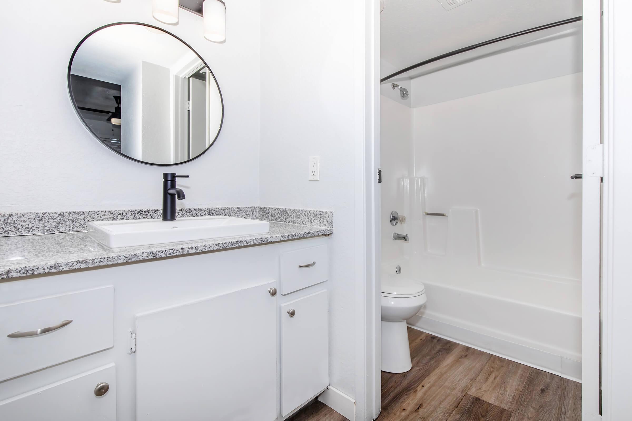 a kitchen with a sink and a mirror