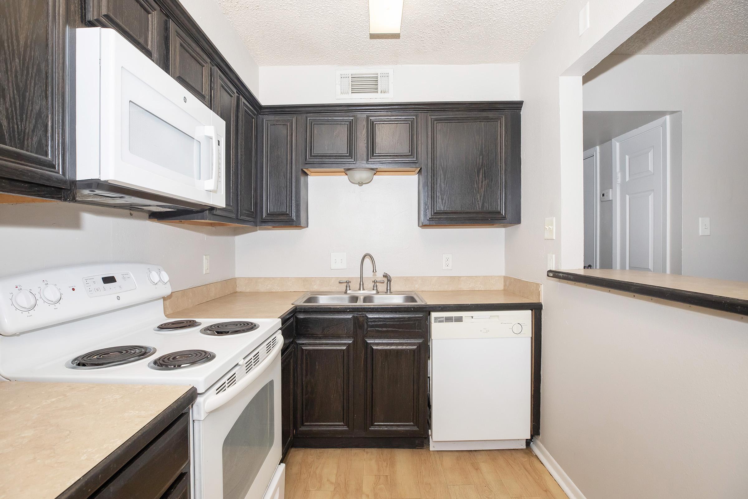 a kitchen with a stove and a sink