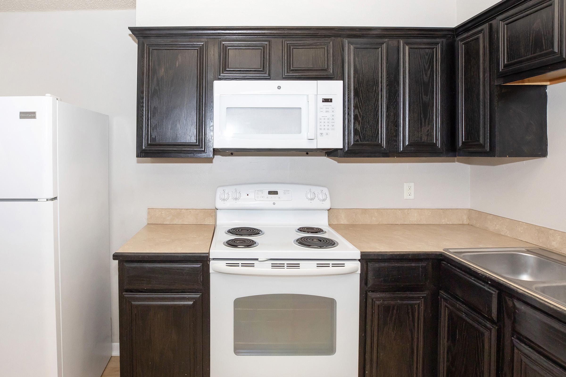 a stove top oven sitting inside of a kitchen