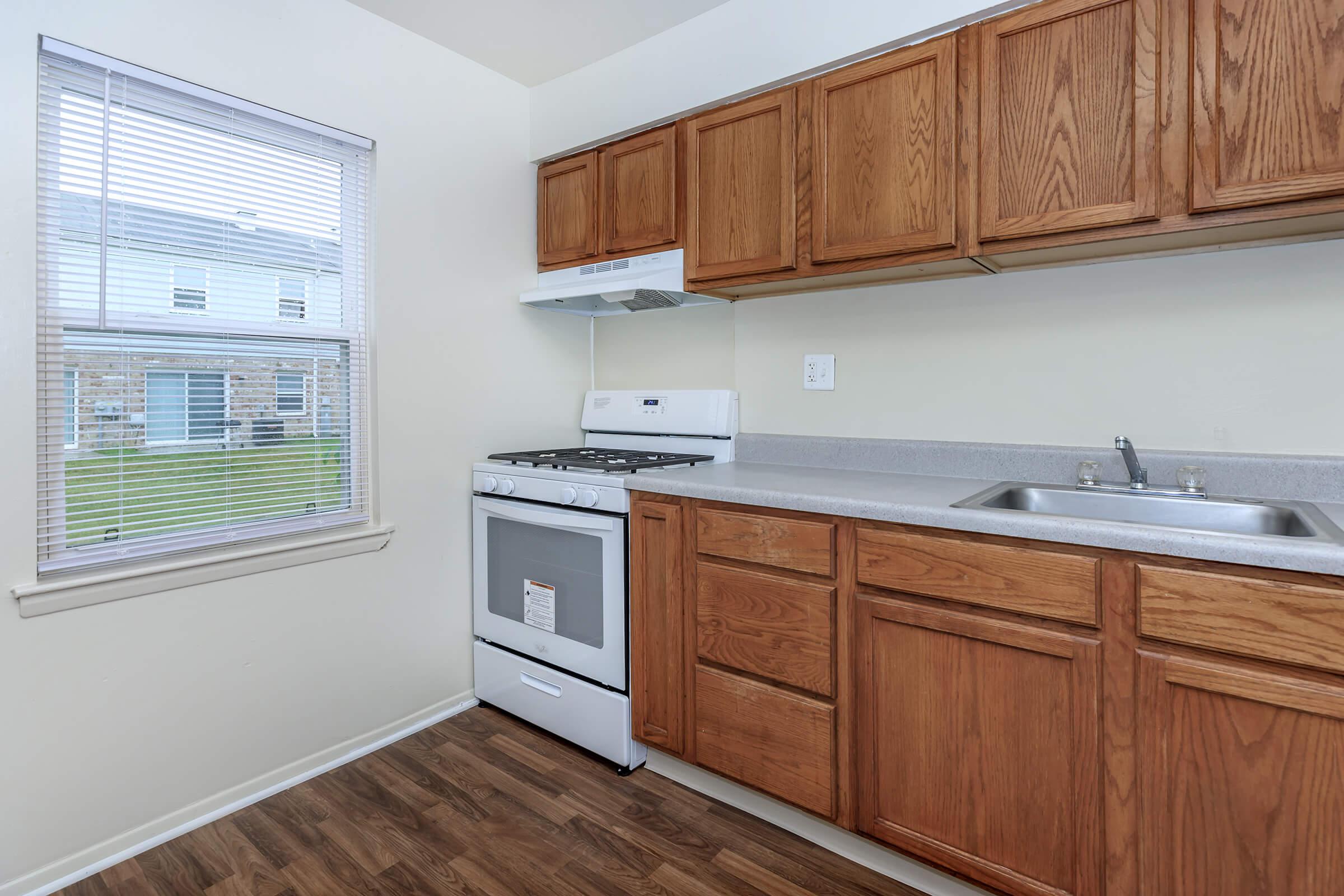 a kitchen with wooden cabinets