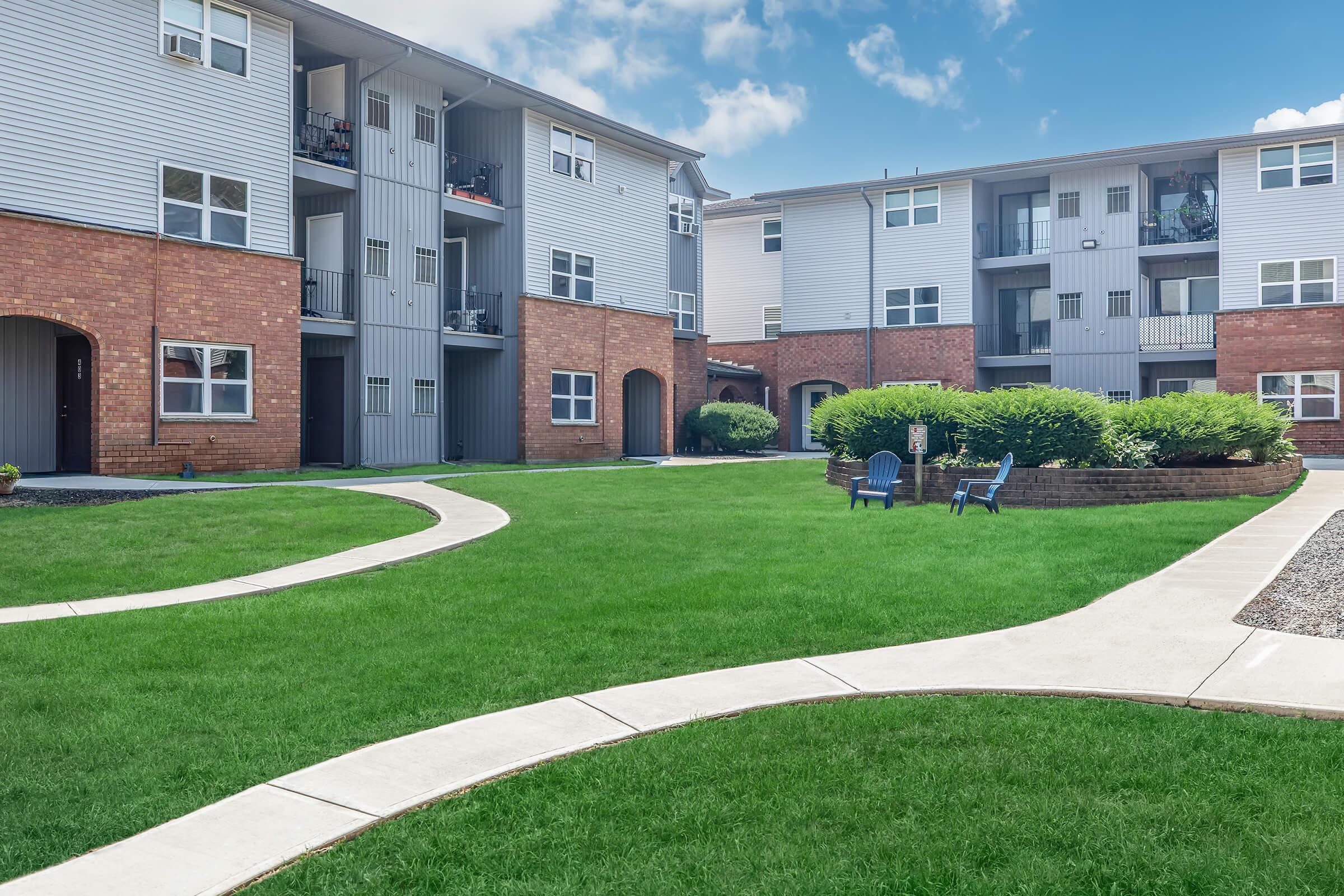 a large lawn in front of a brick building