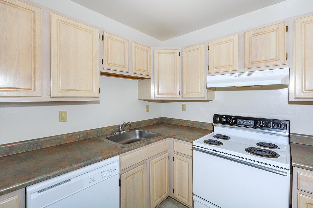 a kitchen with white cabinets and a microwave