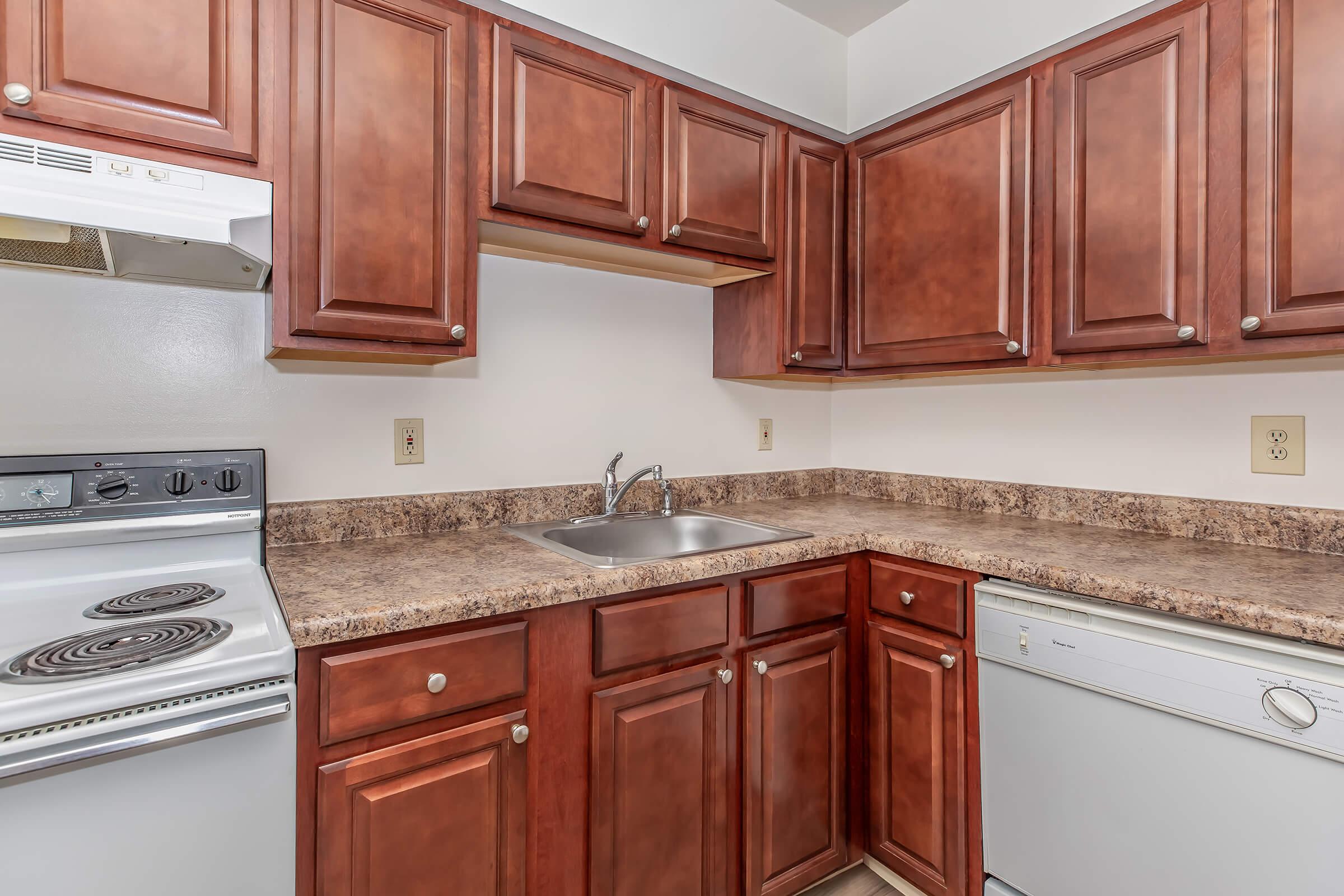 a kitchen with stainless steel appliances and wooden cabinets