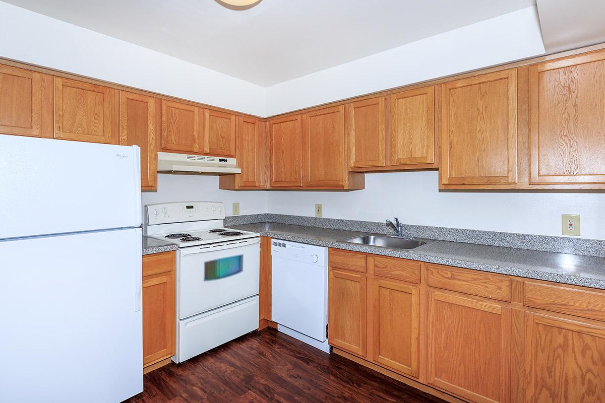 a kitchen with stainless steel appliances and wooden cabinets