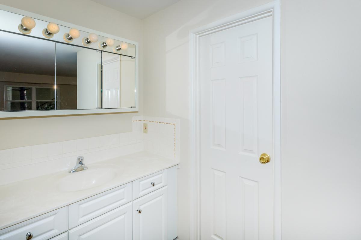 a white sink and a mirror