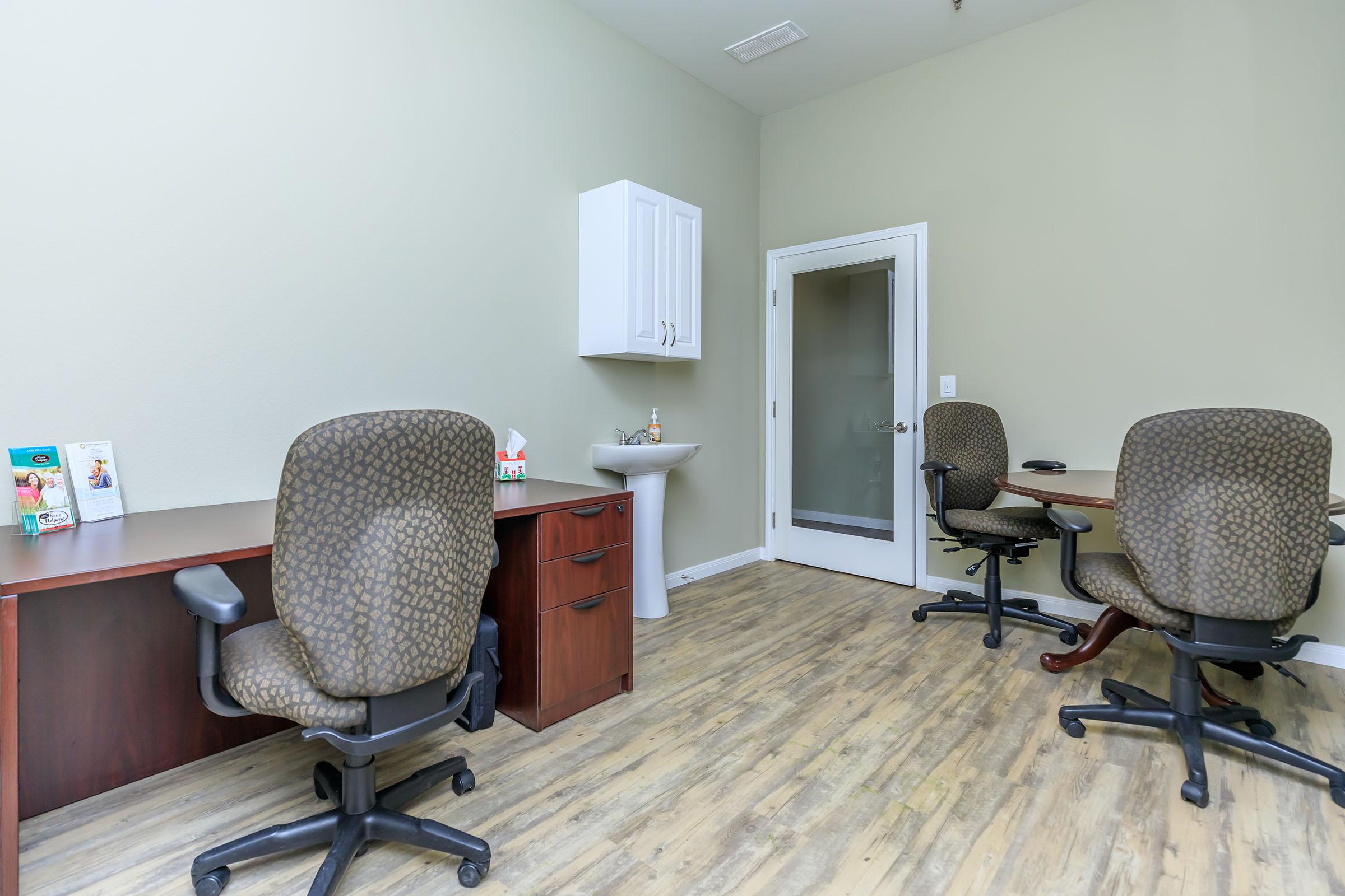 a bedroom with a desk and chair in a room