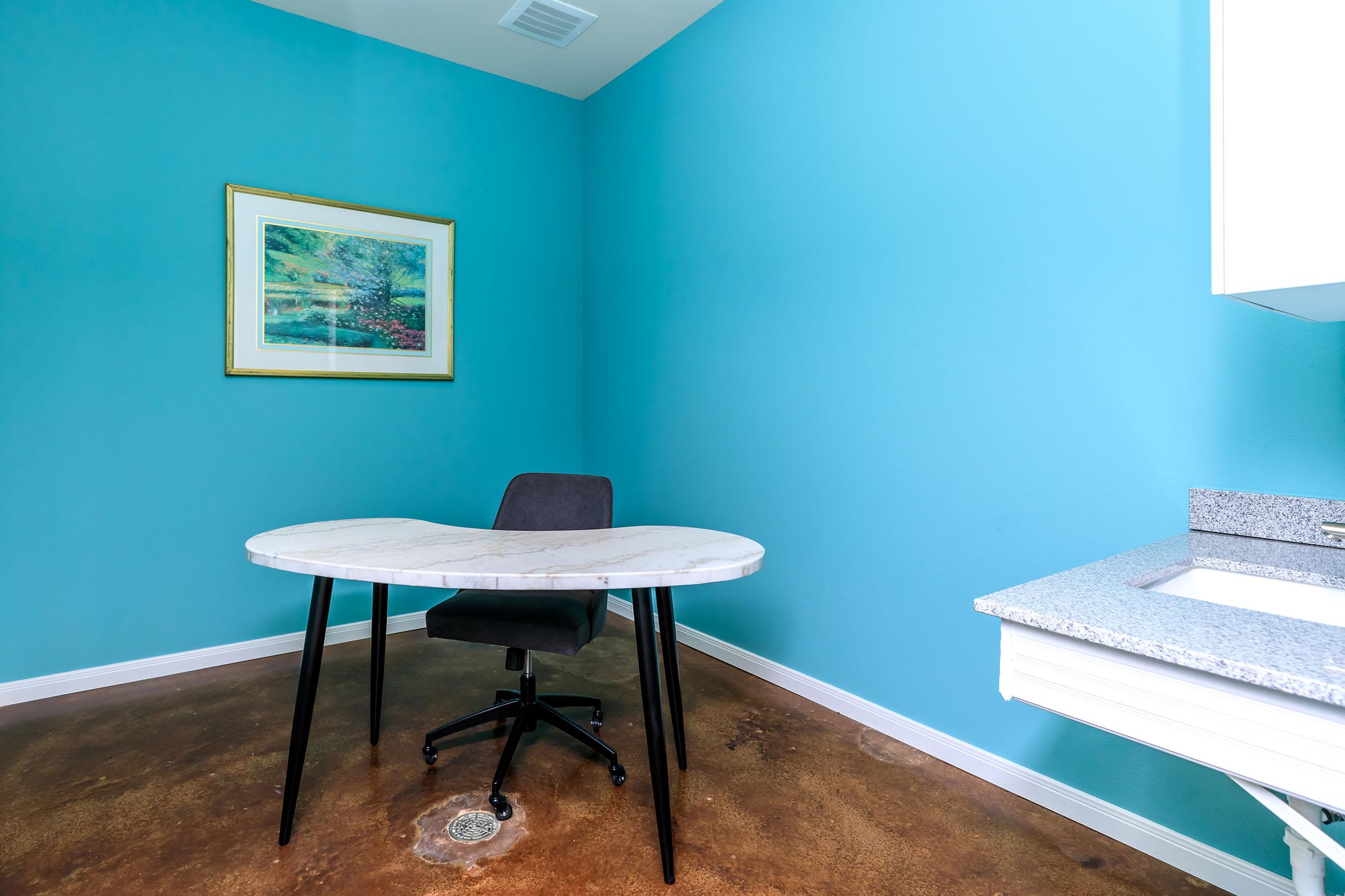 a table topped with a blue chair