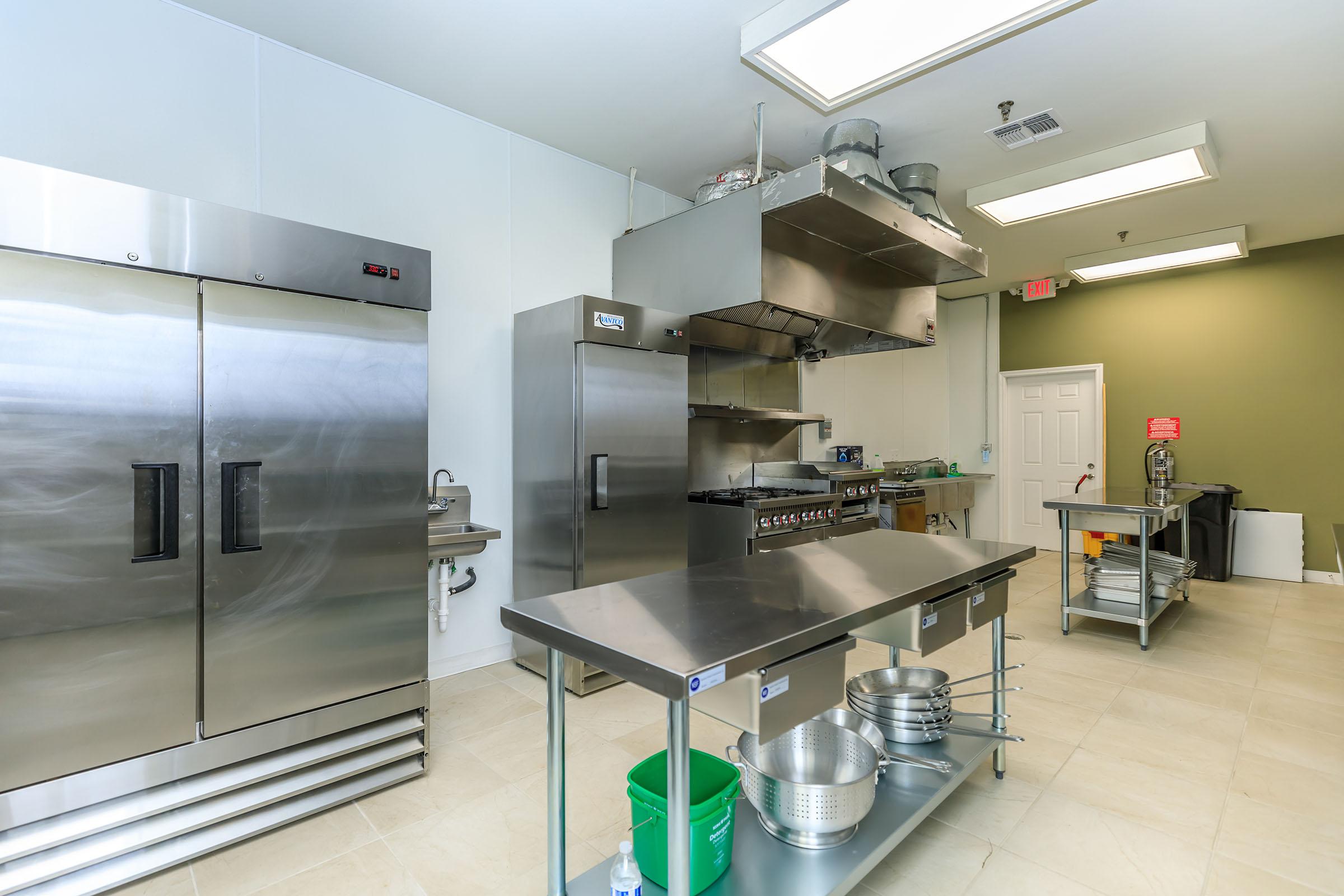 a large kitchen with stainless steel appliances