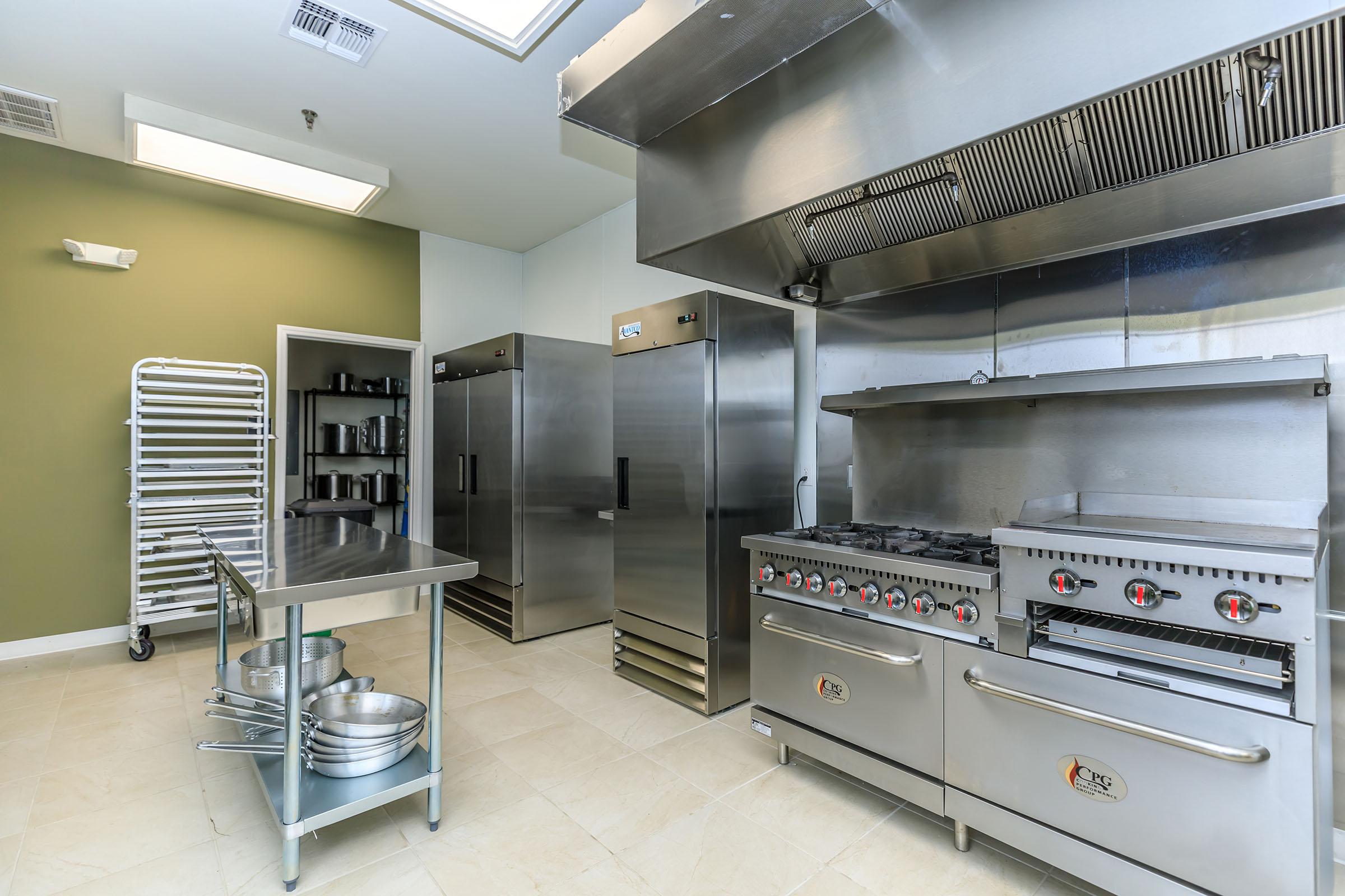 a large kitchen with stainless steel appliances