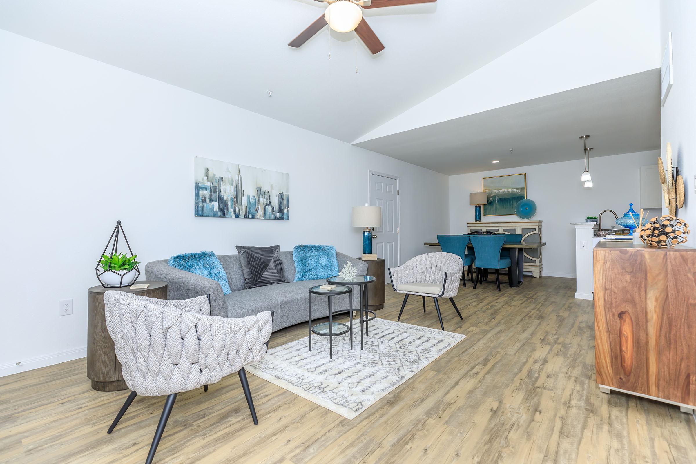 a living room filled with furniture on top of a wooden table