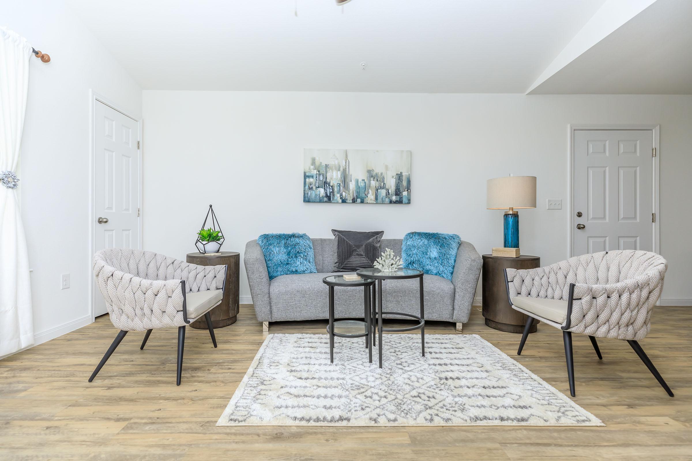 a living room filled with furniture and a rug