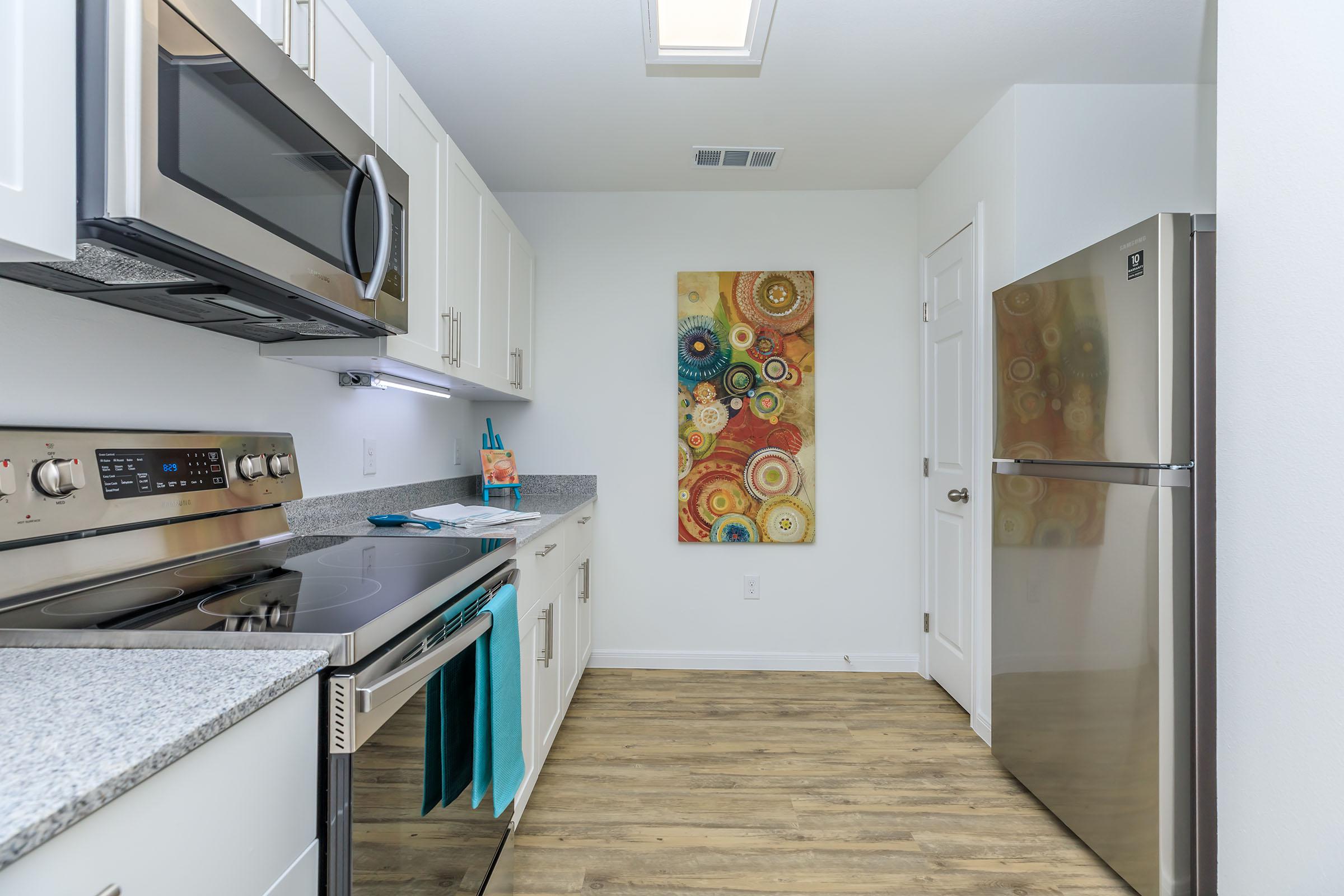 a stove top oven sitting inside of a kitchen