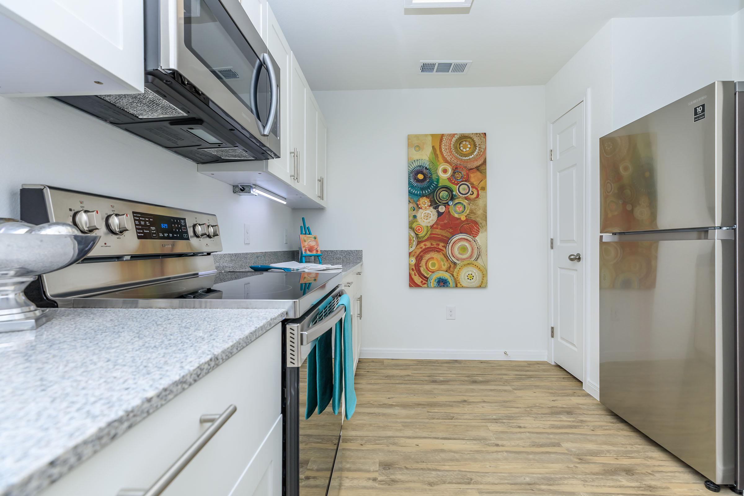 a kitchen with a stove and a refrigerator