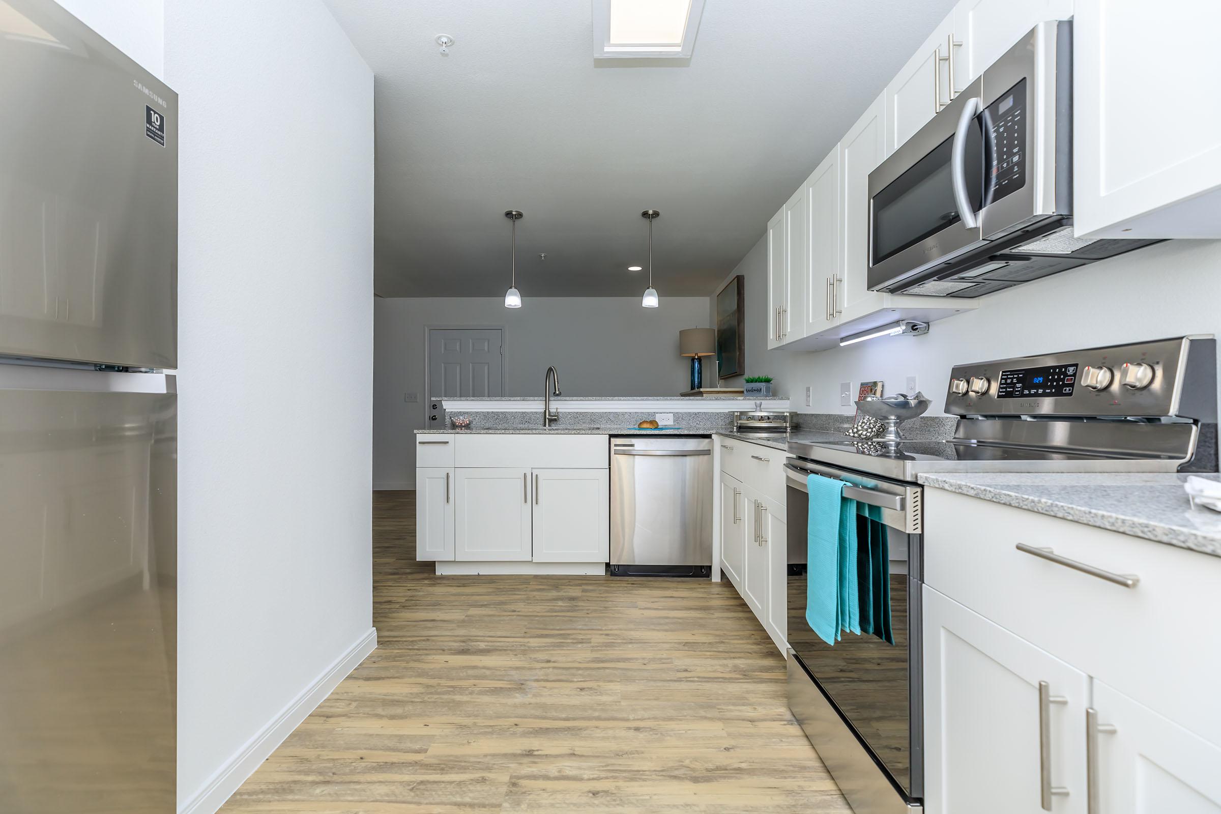 a kitchen with a sink and a refrigerator