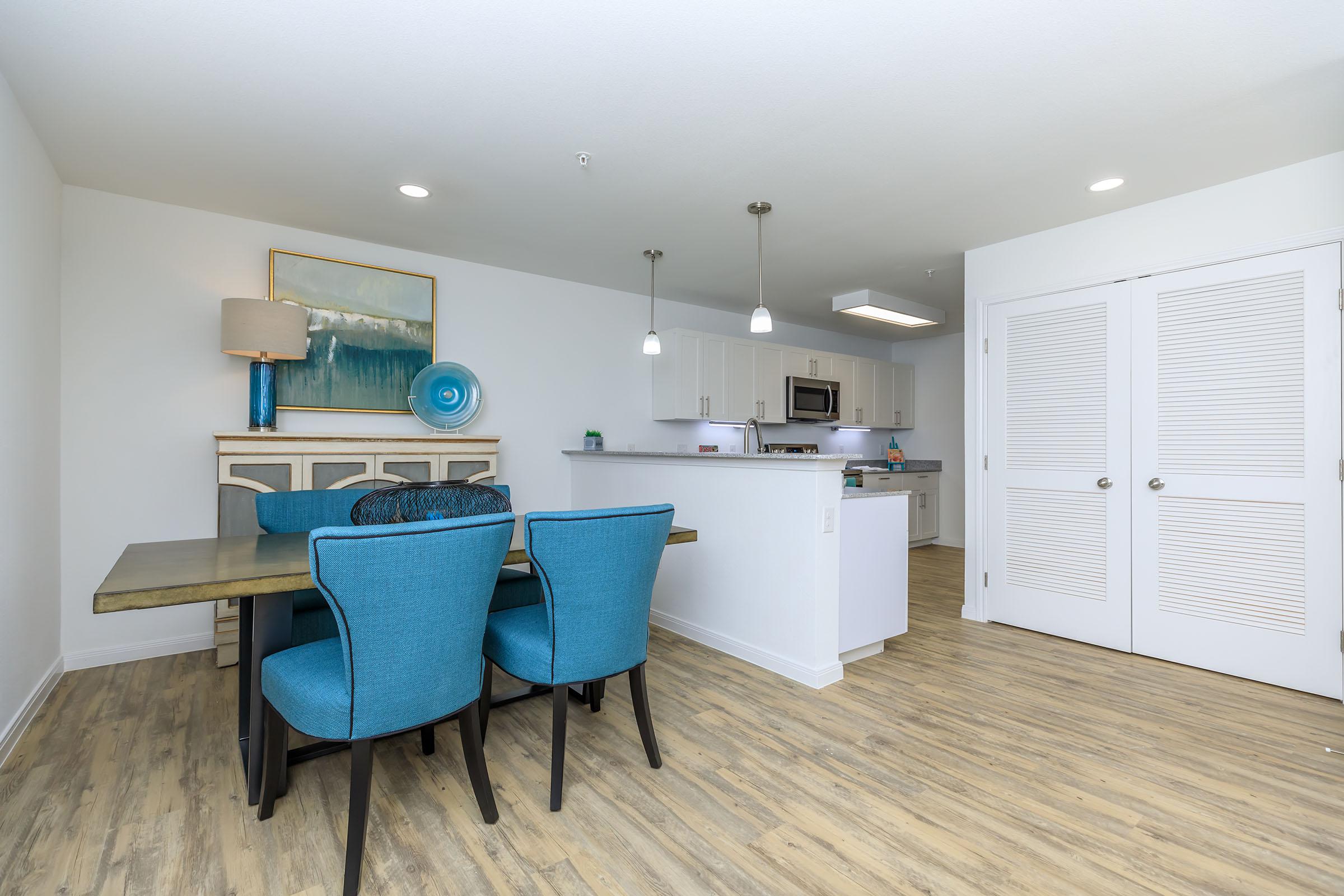 a kitchen with a blue chair in a room