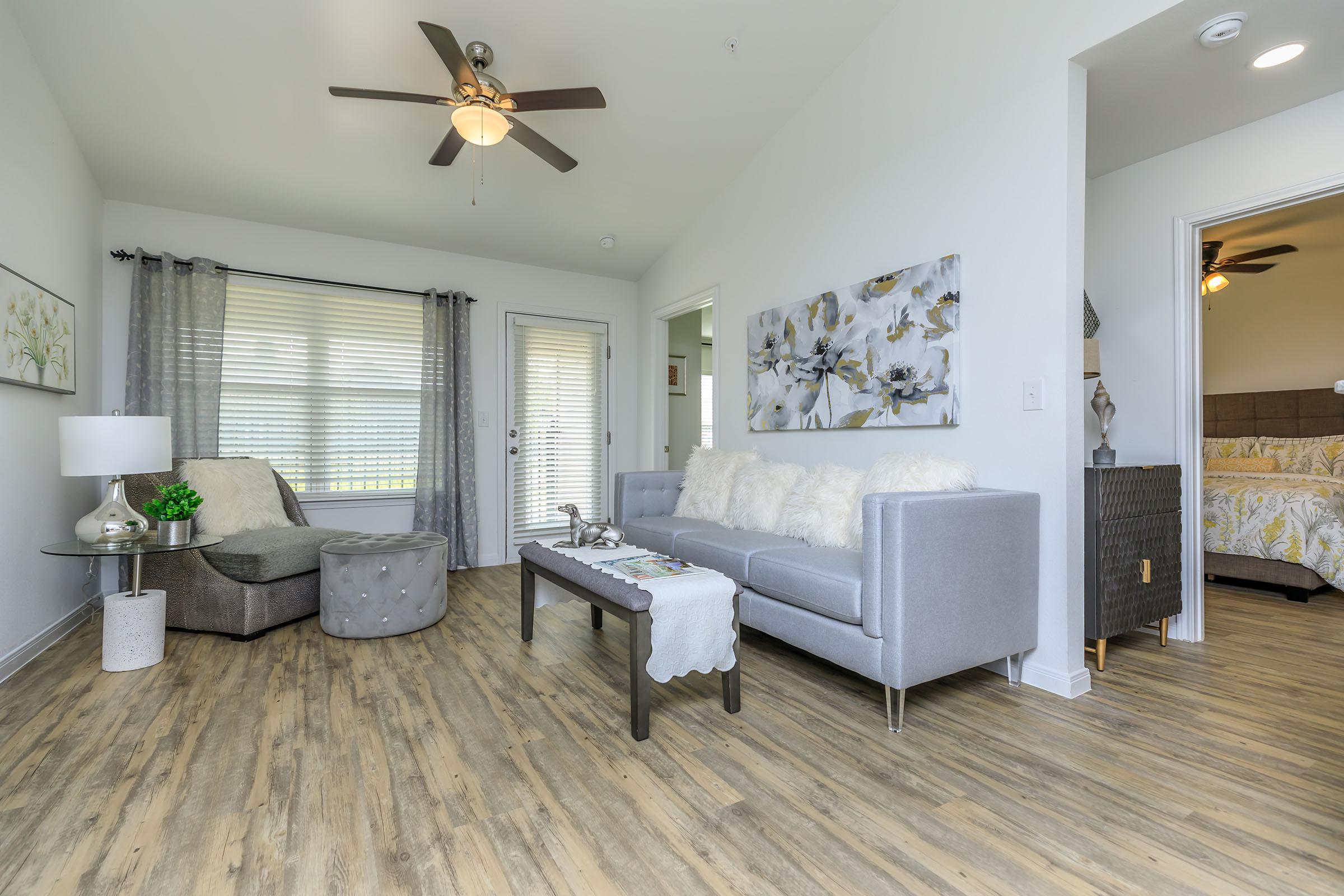 a living room filled with furniture and a large window