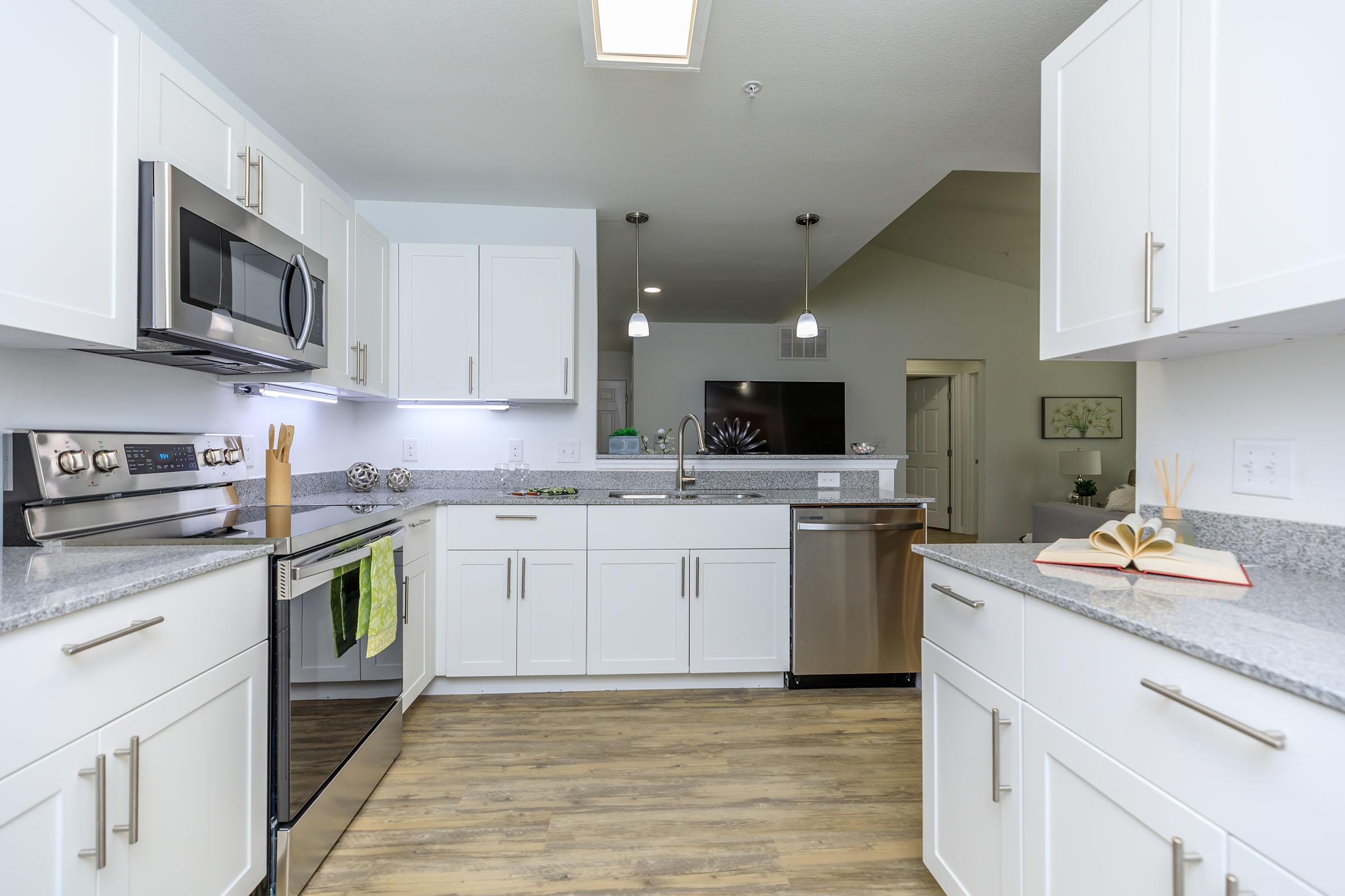 a kitchen with a stove sink and refrigerator