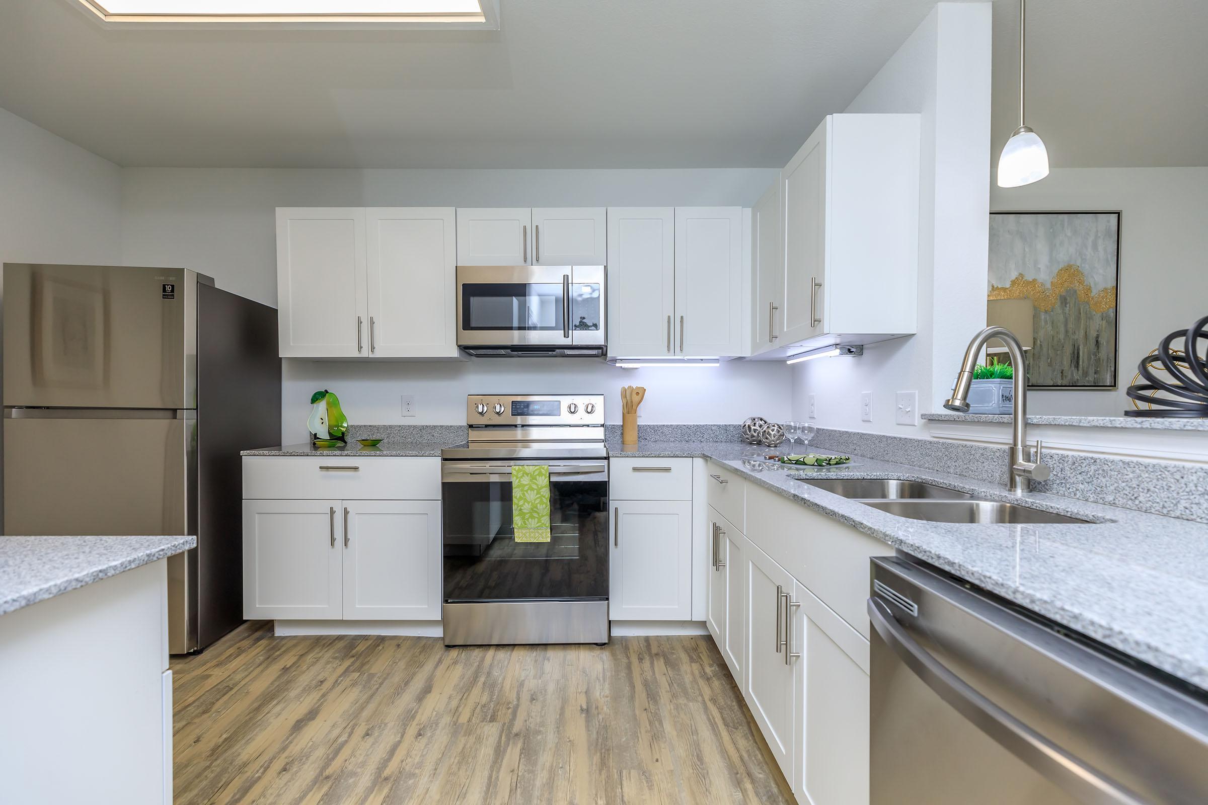 a kitchen with a stove sink and refrigerator