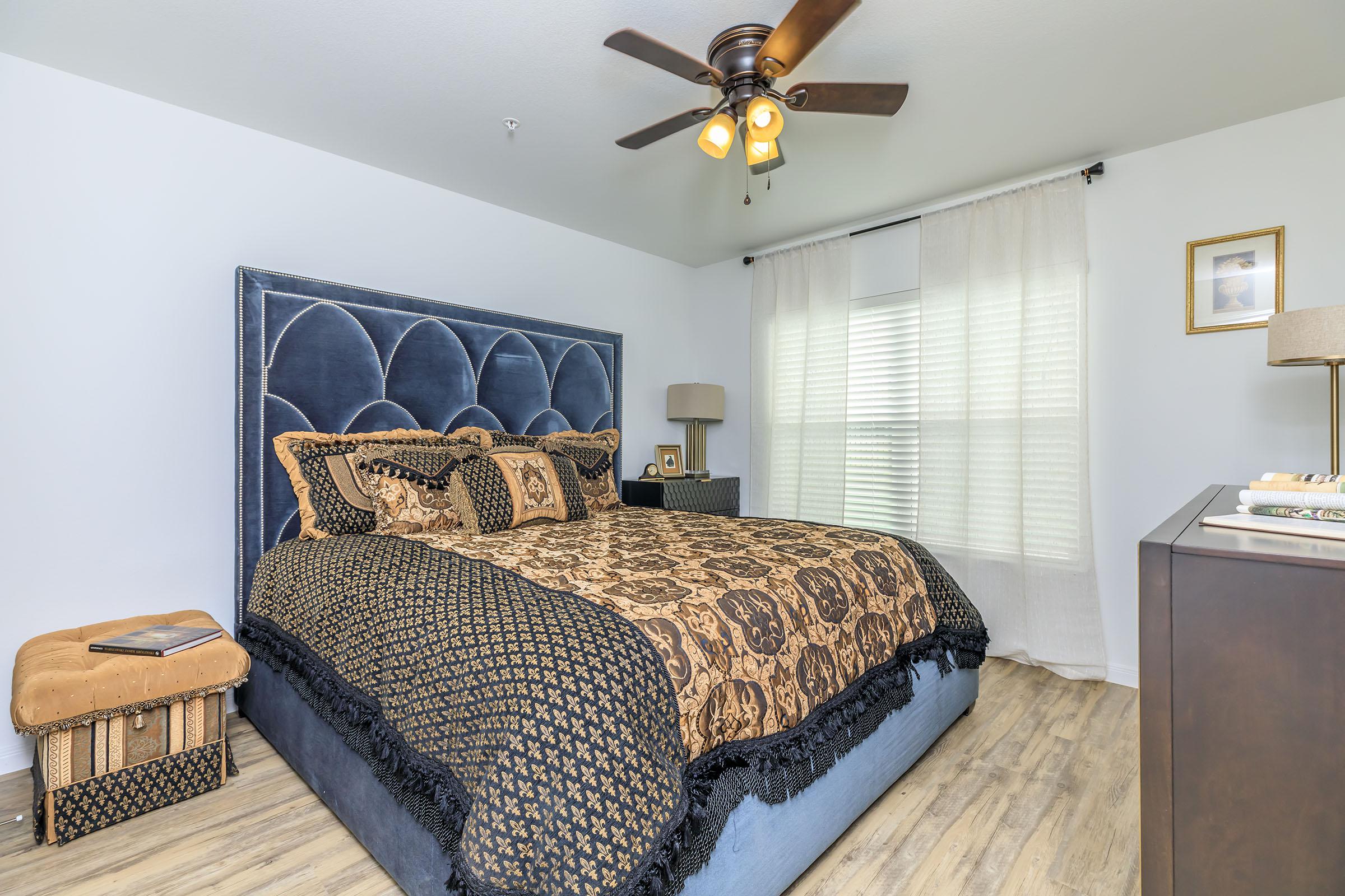 a bedroom with a bed and desk in a room