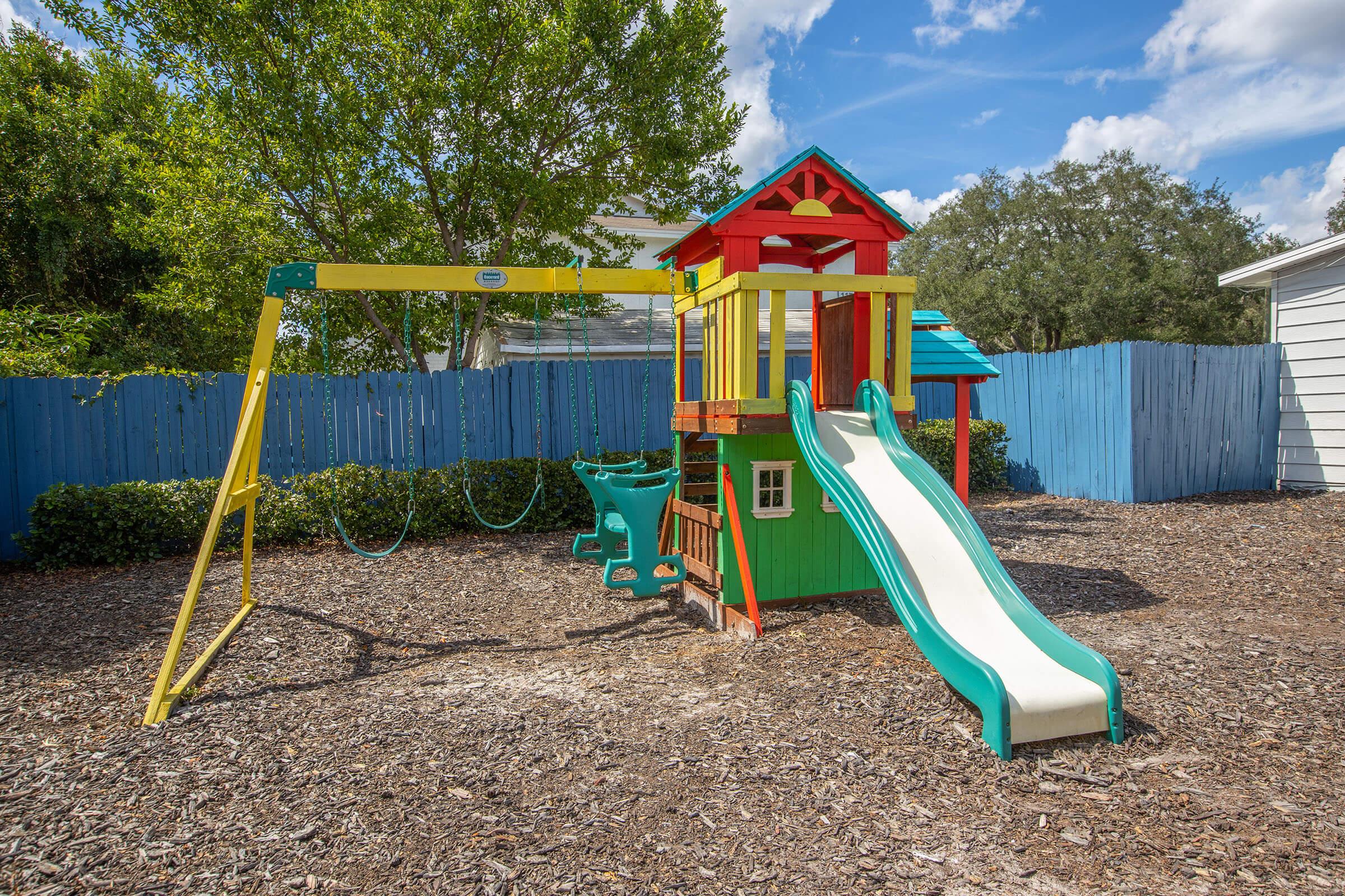 a playground in front of a fence