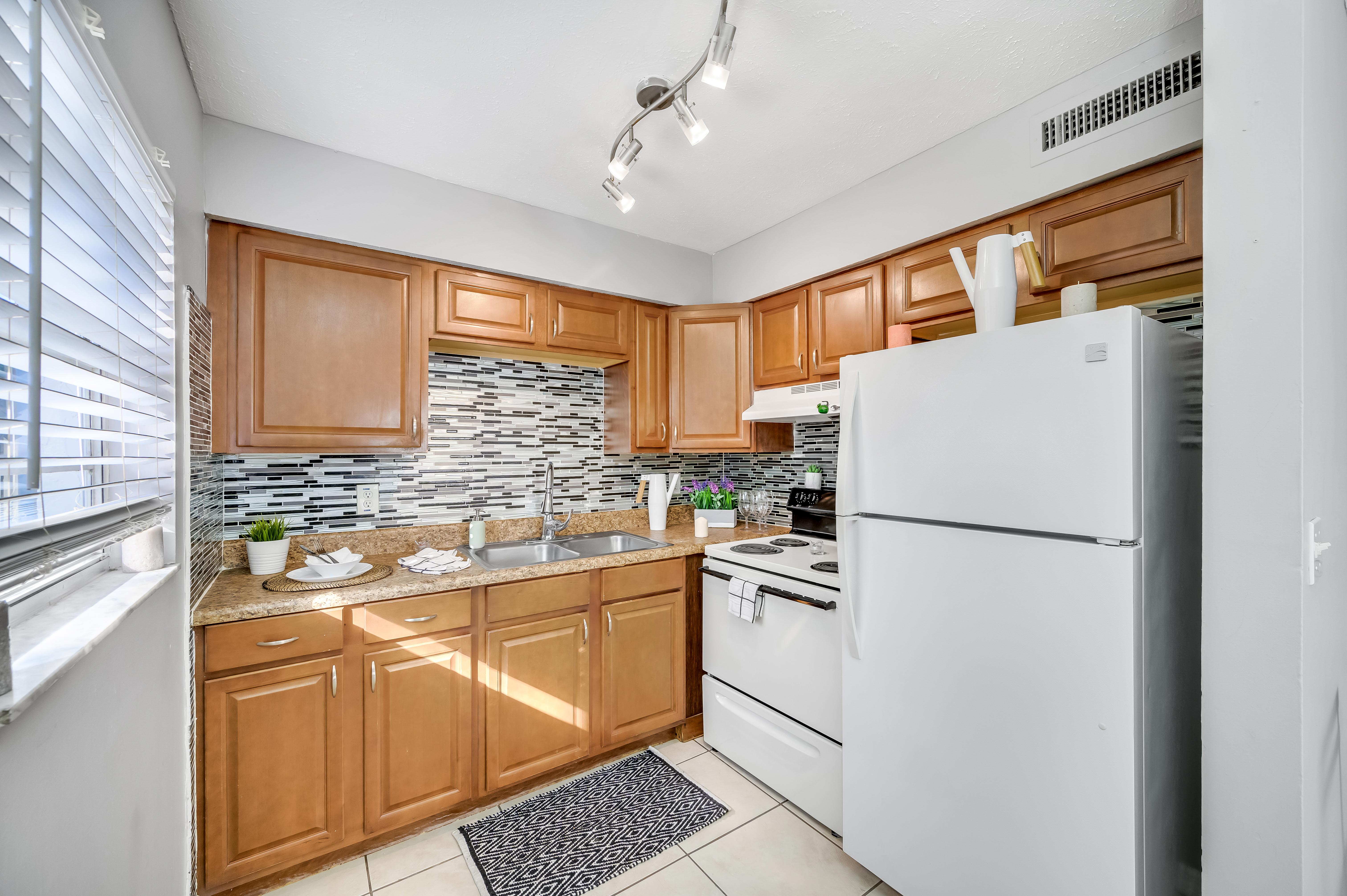 a kitchen with a stove and a refrigerator