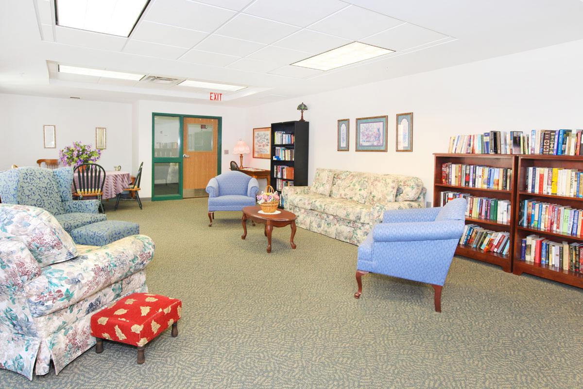 a living room filled with furniture and a book shelf