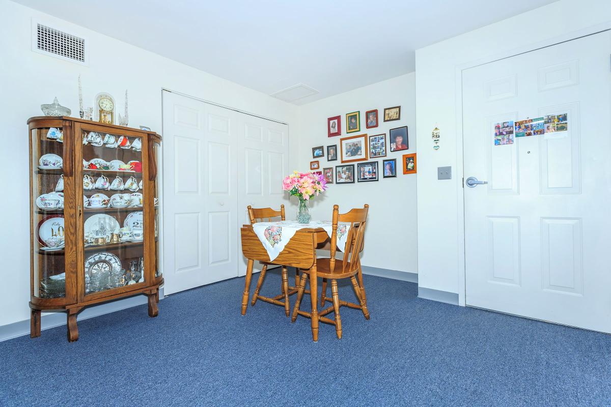 a living room filled with furniture and a refrigerator