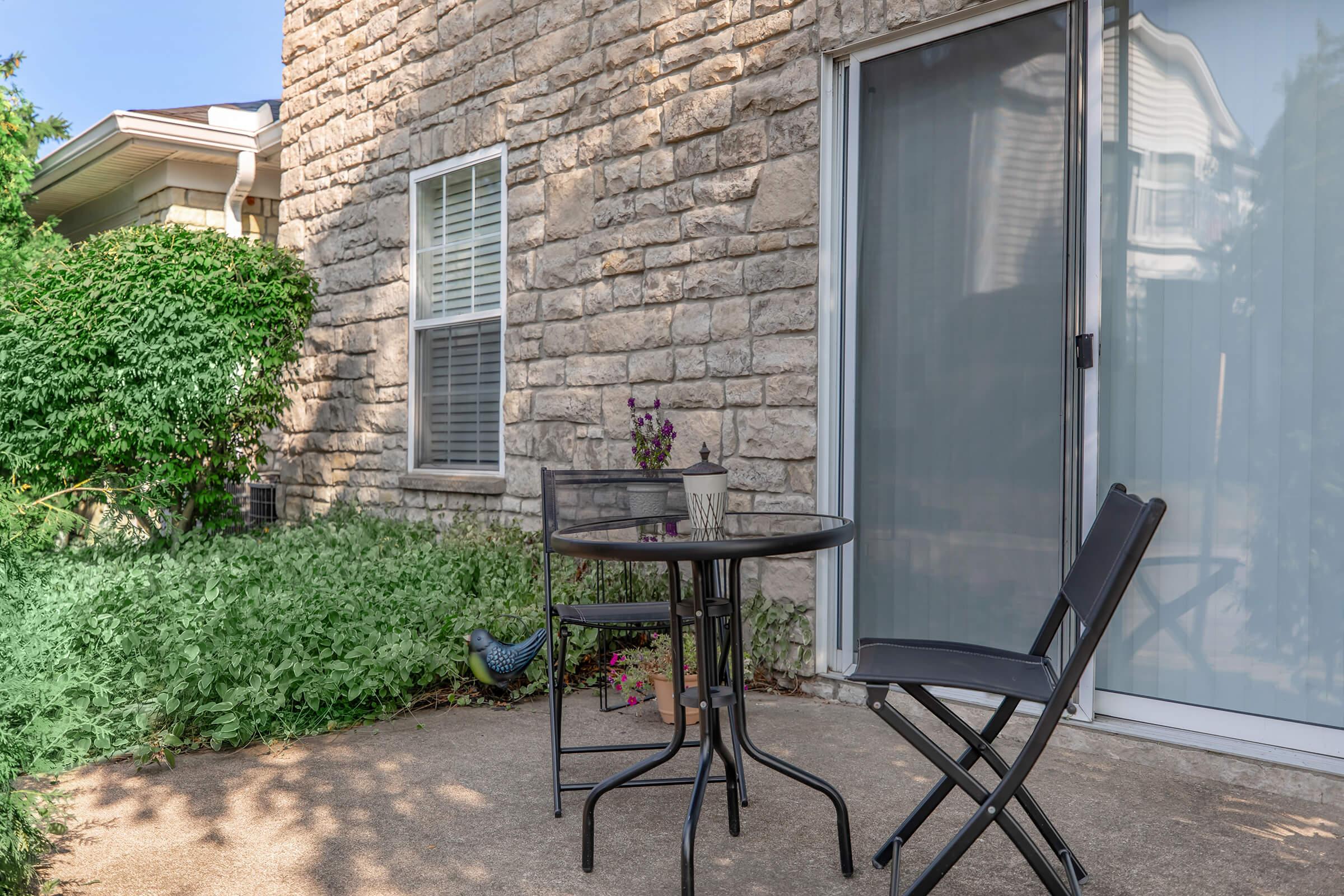 a chair sitting in front of a brick building