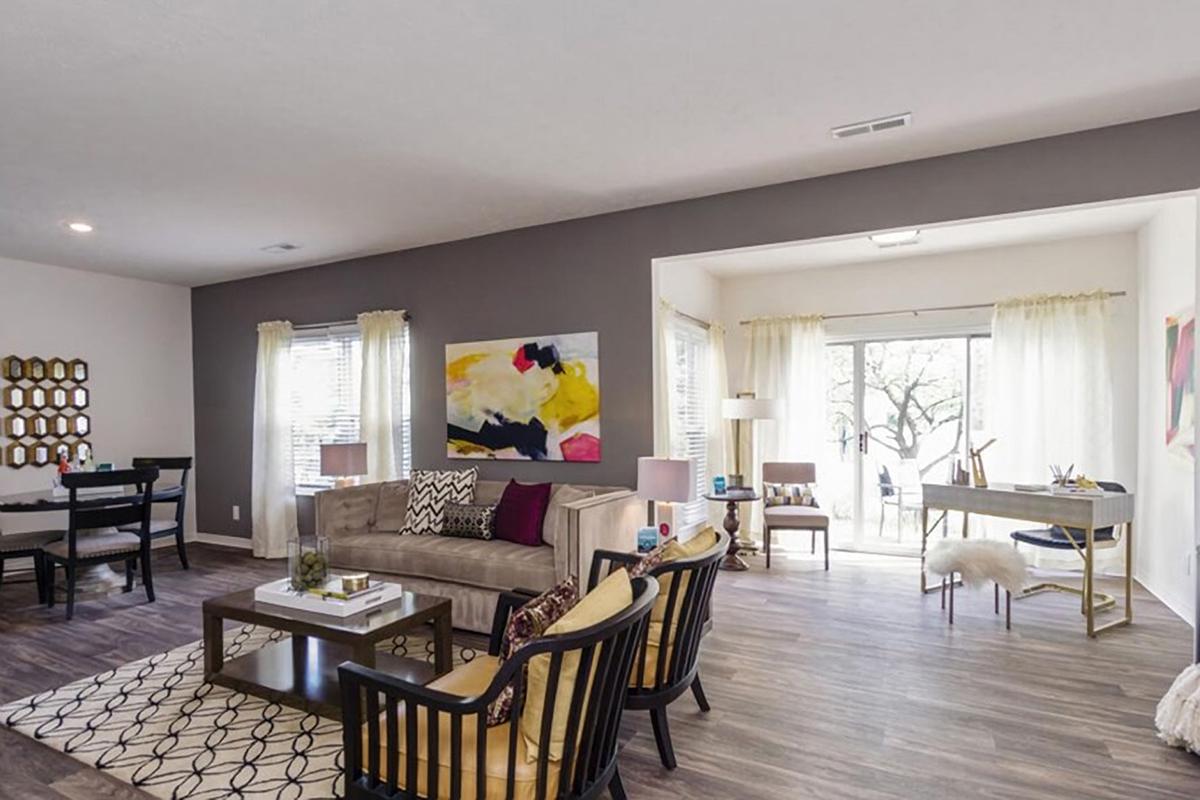 a living room filled with furniture and a large window