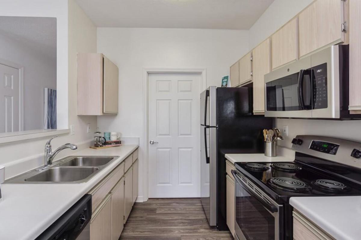 a kitchen with a stove a sink and a microwave