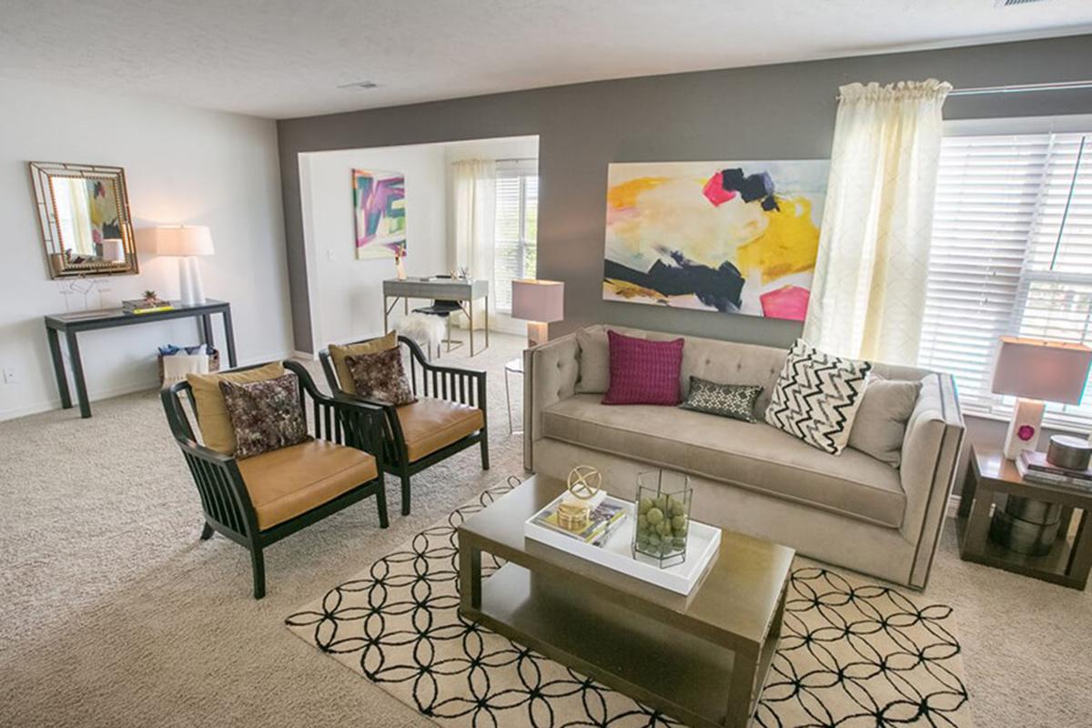 a living room filled with furniture and a large window