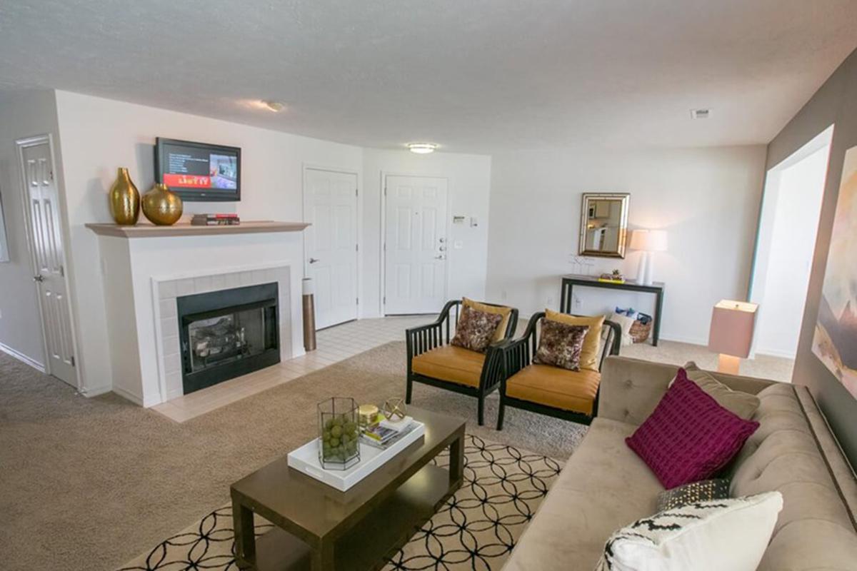 a living room filled with furniture and a flat screen tv