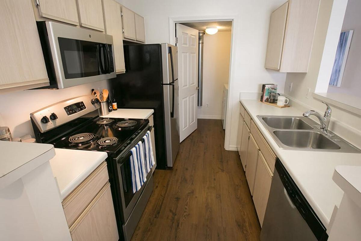 a kitchen with a stove a sink and a microwave