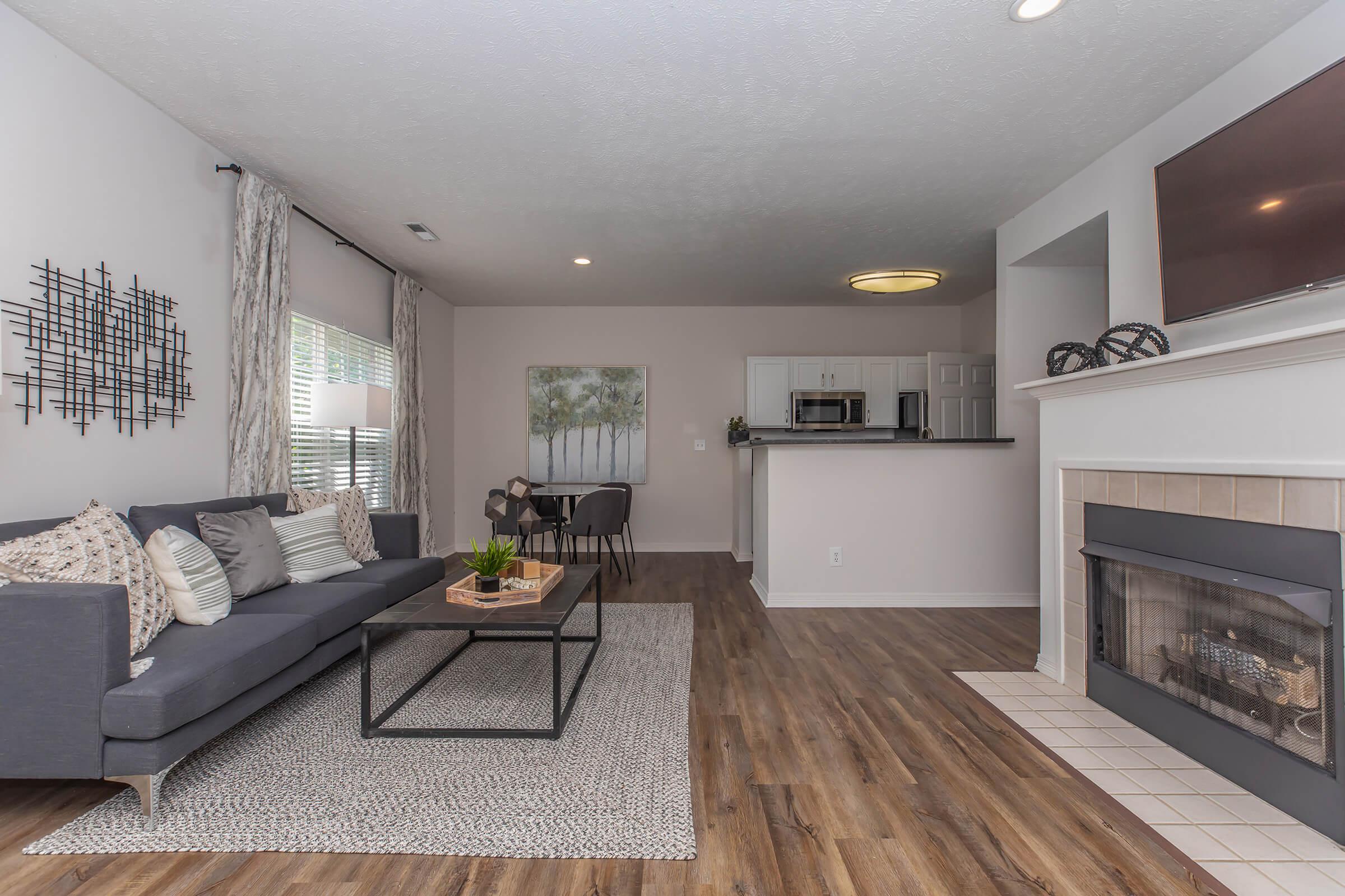 a living room filled with furniture and a large window