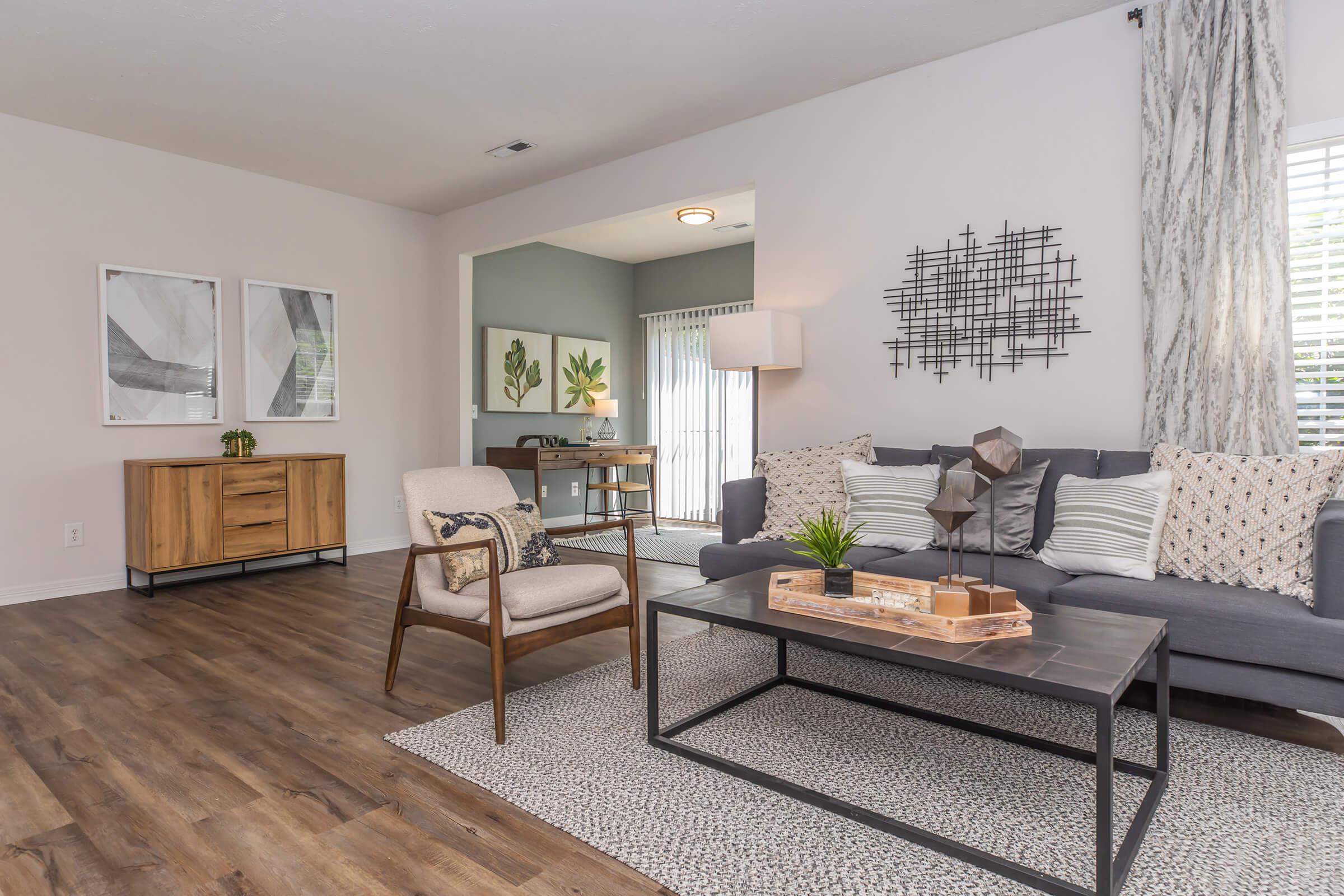 a living room filled with furniture and a large window