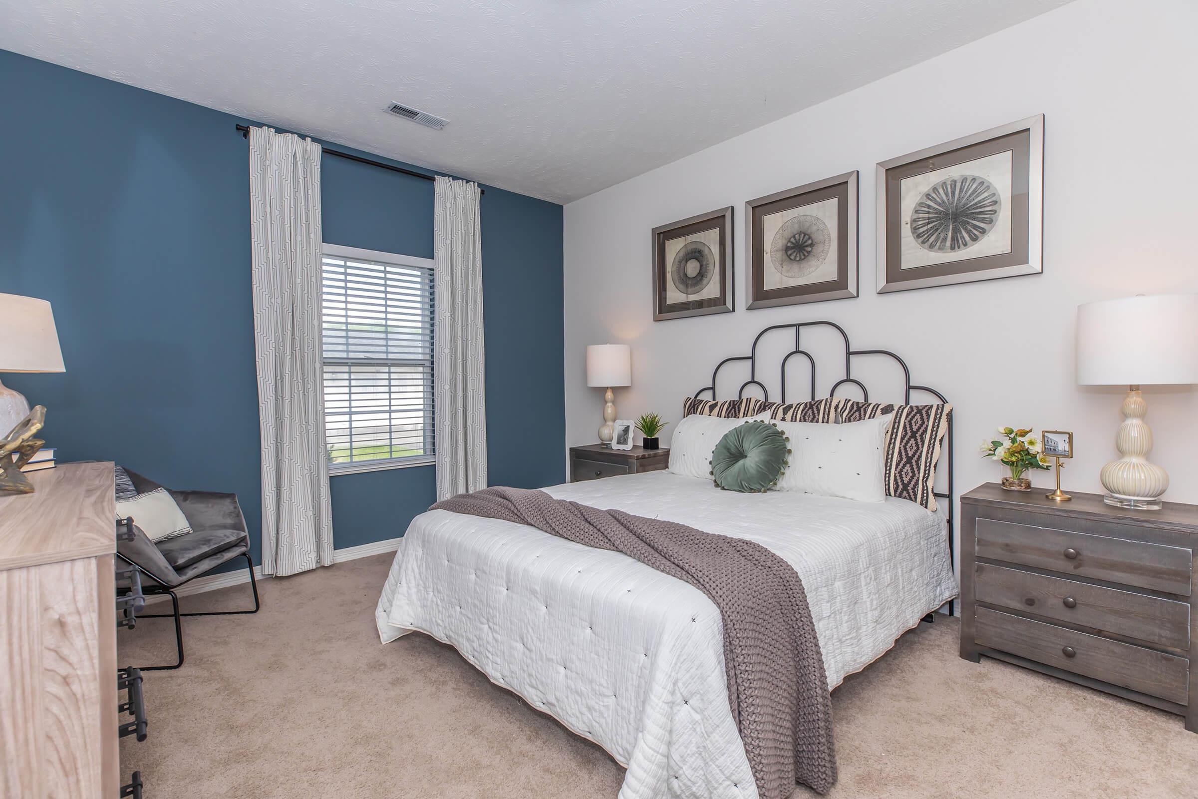 a bedroom with a bed and desk in a room