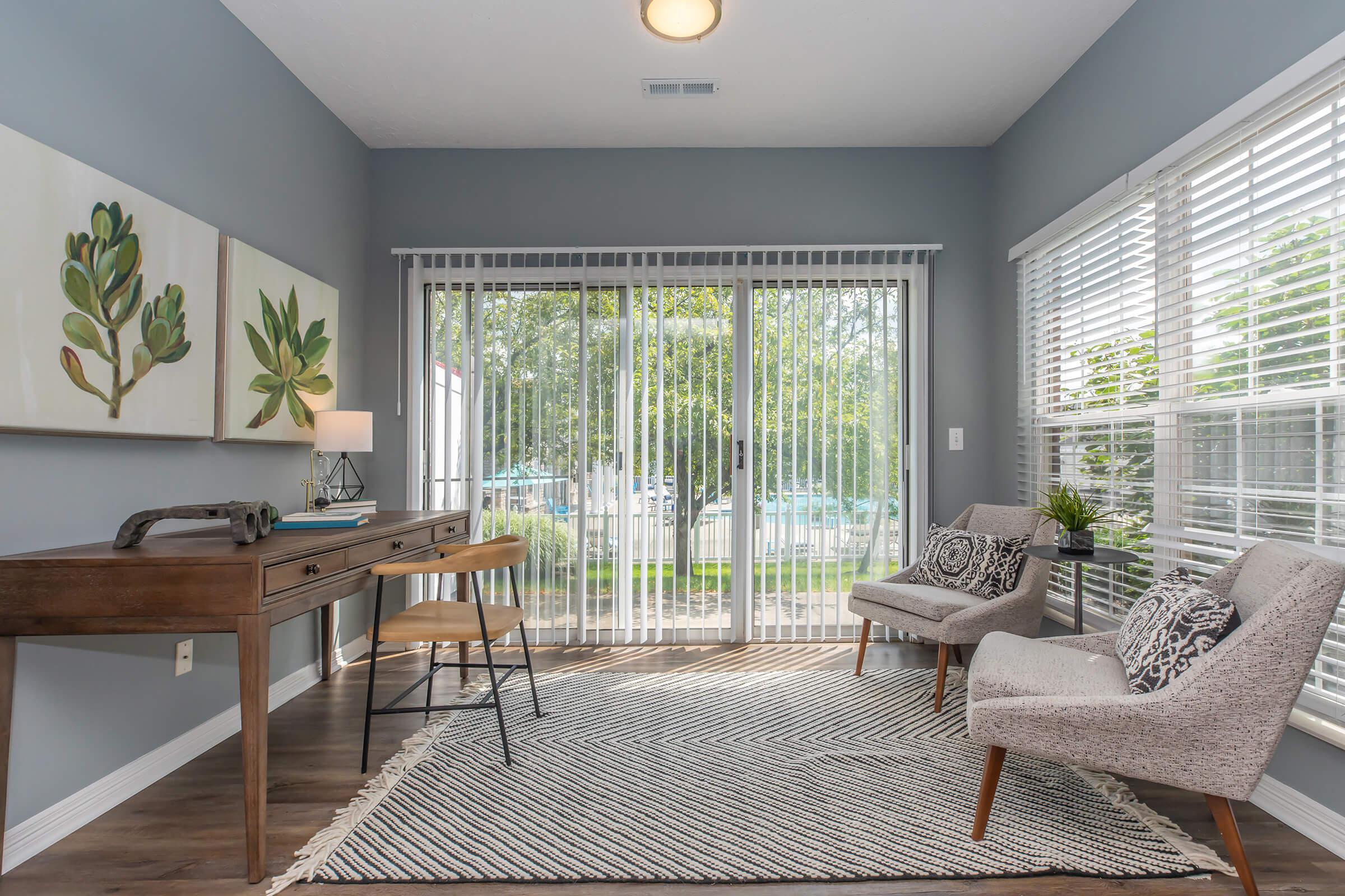 a living room filled with furniture and a large window