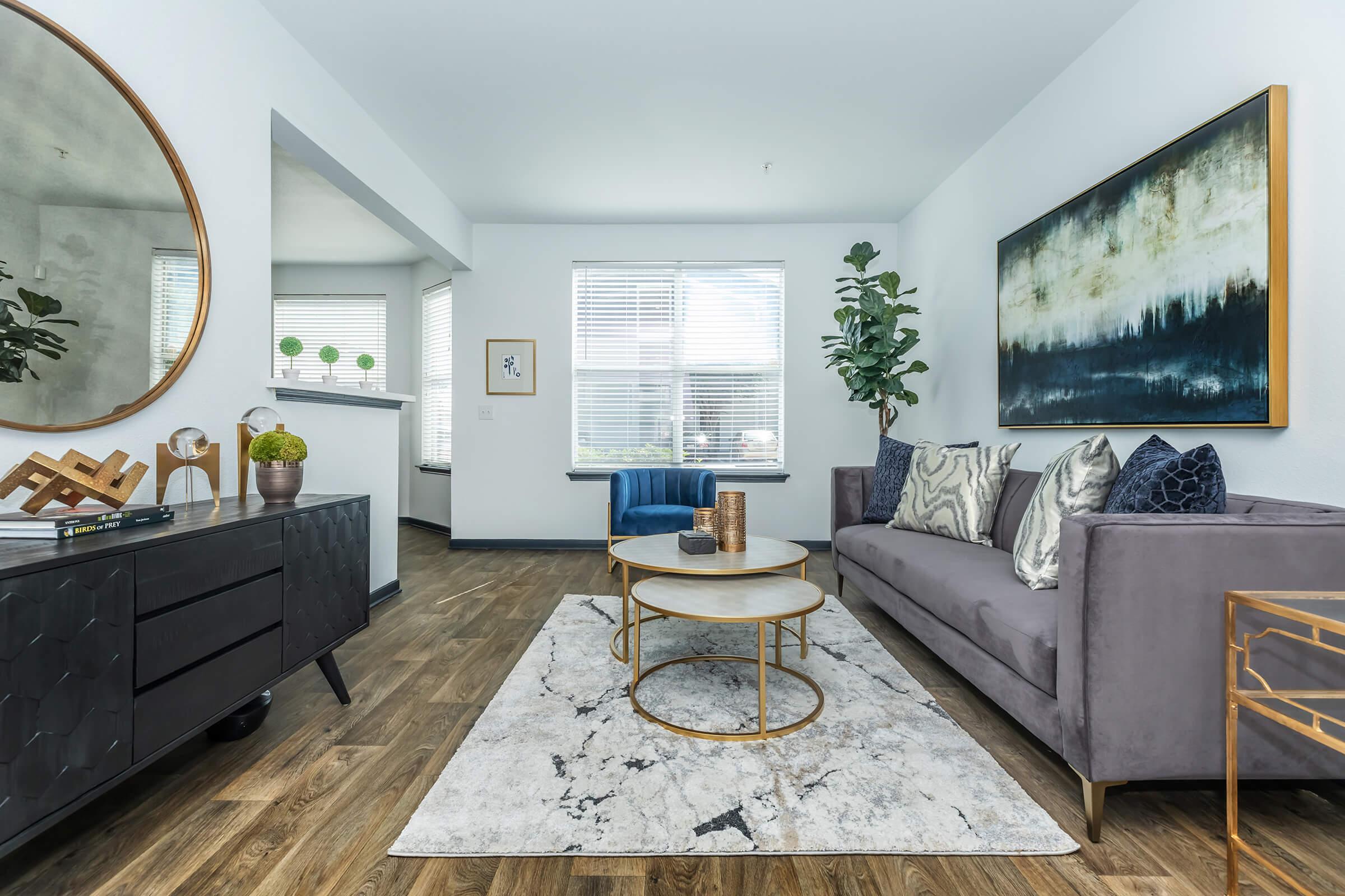a living room filled with furniture and a large window