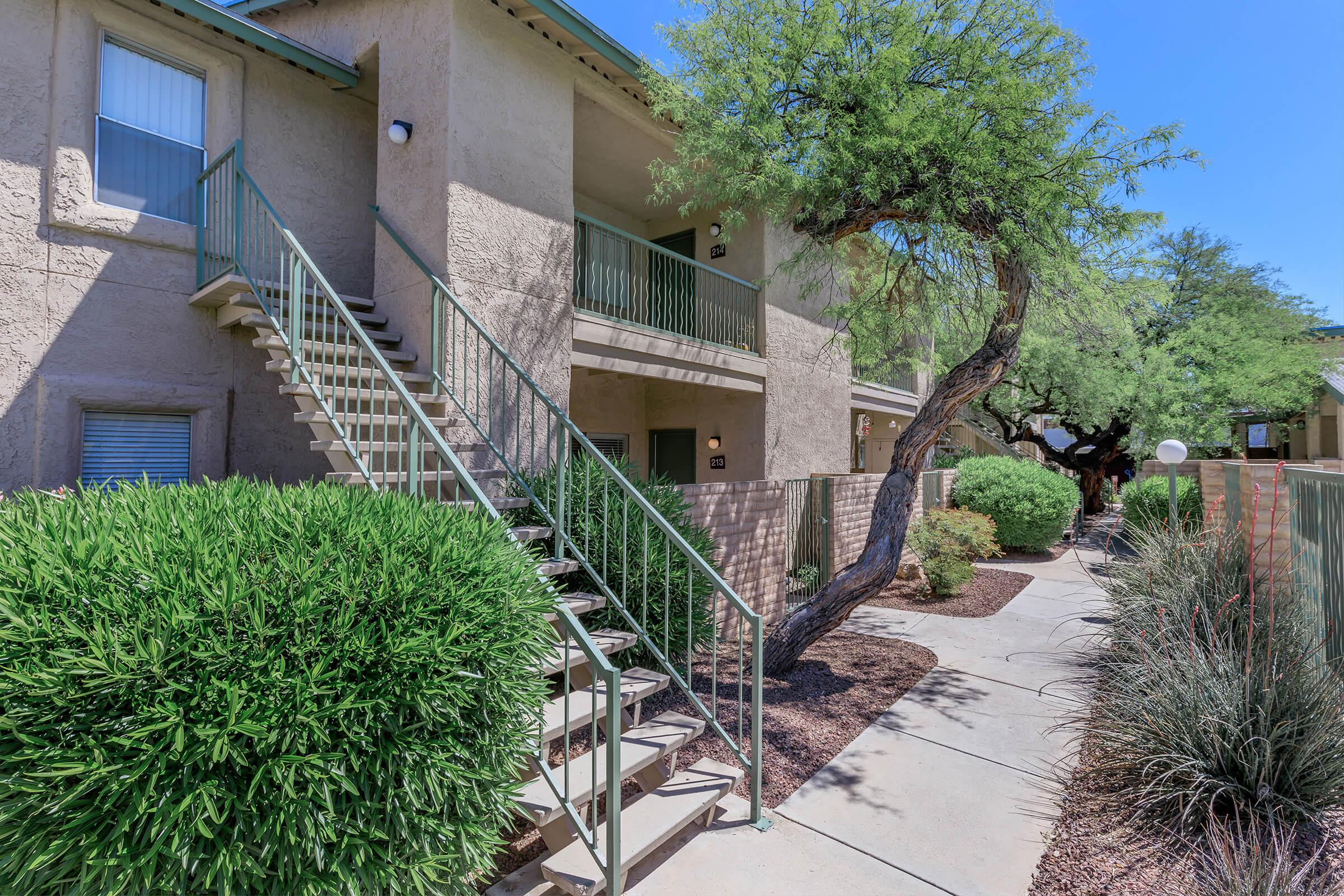 a house with bushes in front of a building