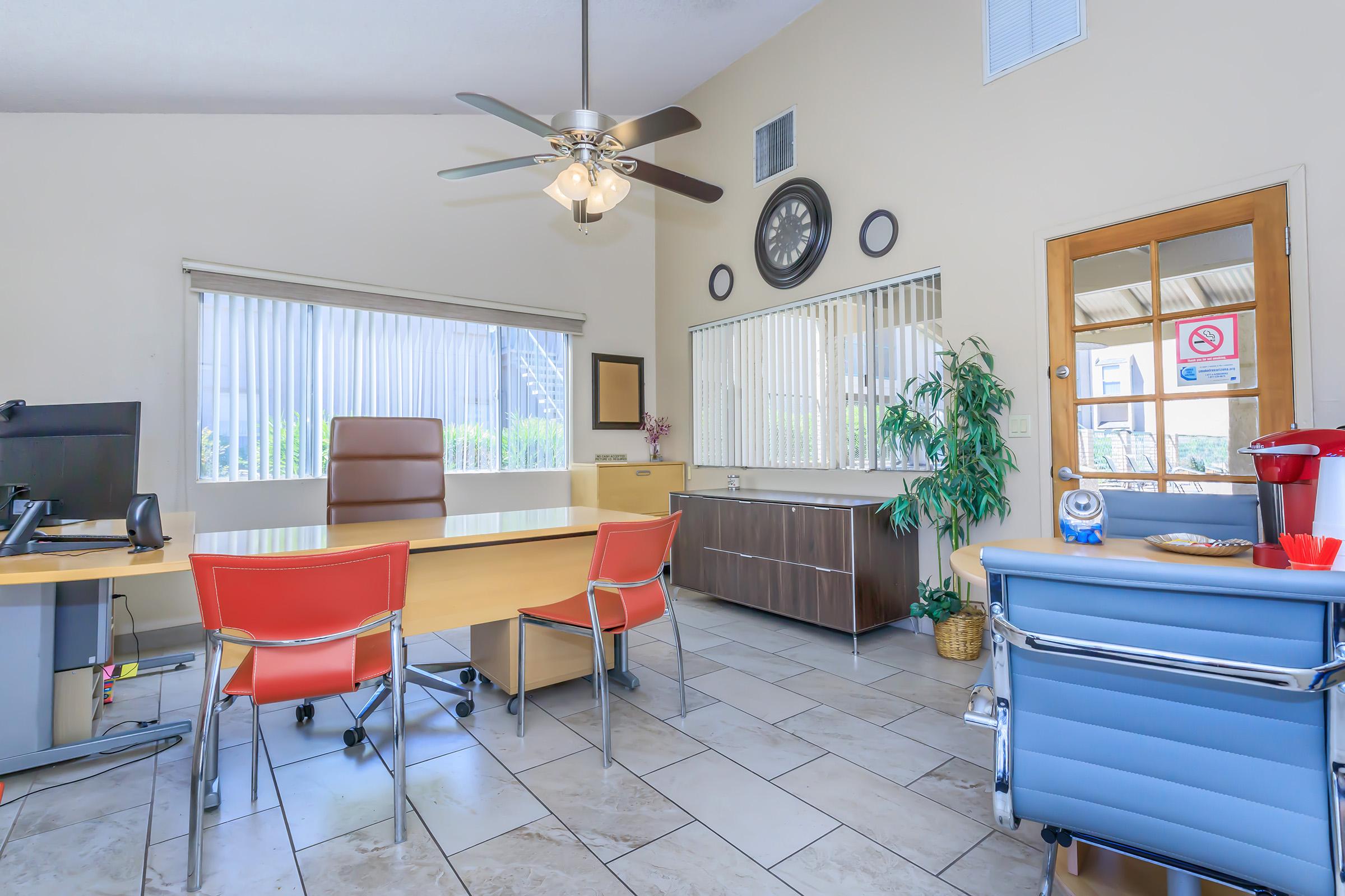 a living room filled with furniture and a large window