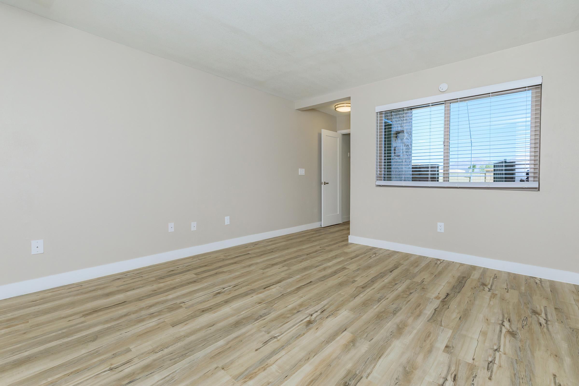 a large empty room with a wooden floor