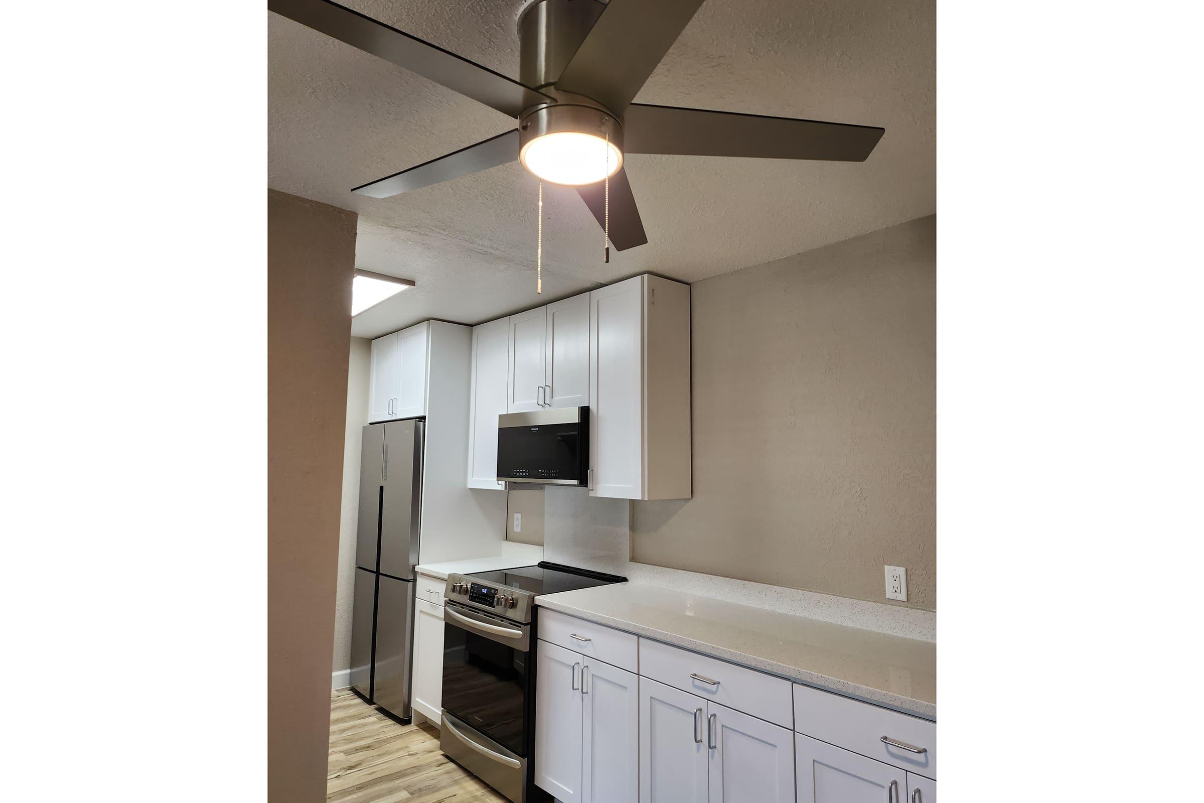 a kitchen with a sink and a mirror