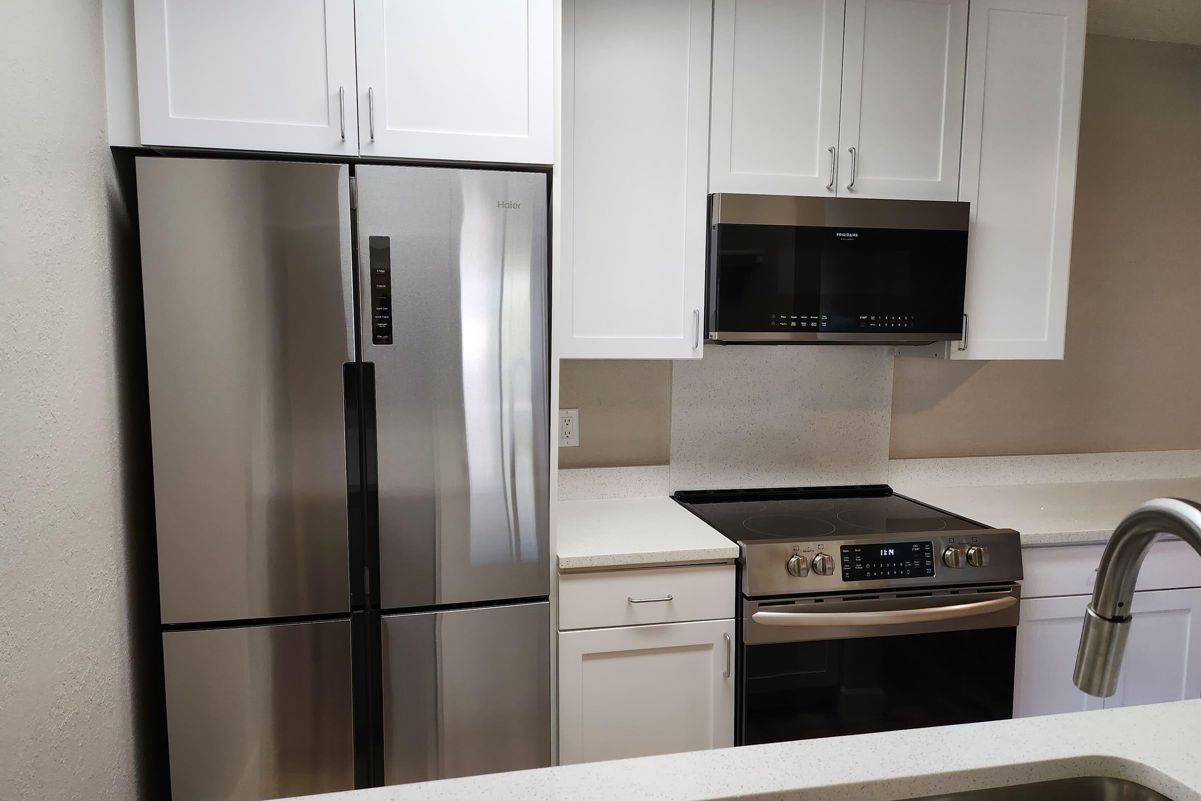 a kitchen with a stove top oven sitting inside of a refrigerator