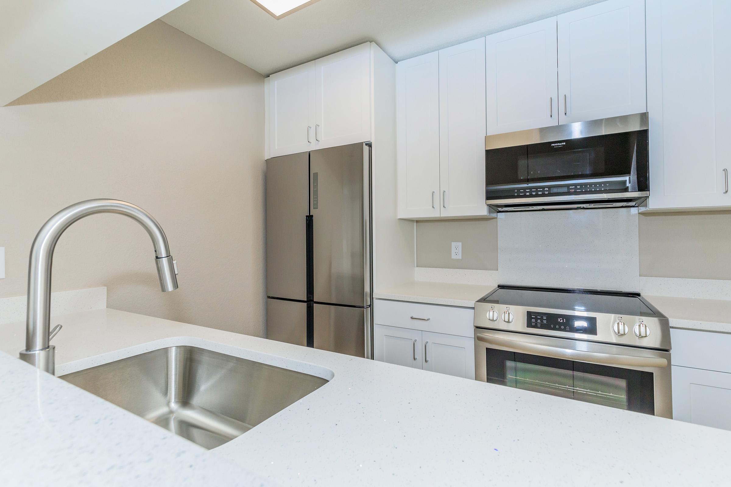 a kitchen with a sink and a microwave