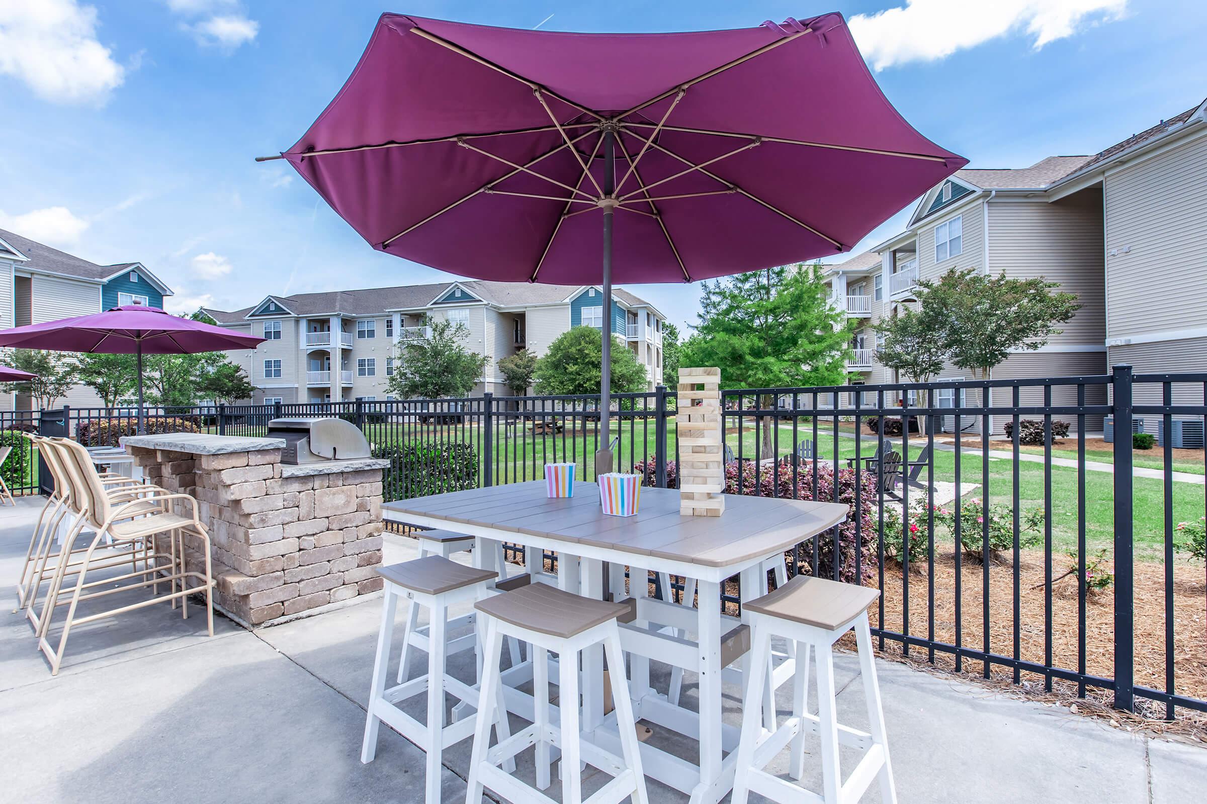 an umbrella sitting on a chair in front of a building