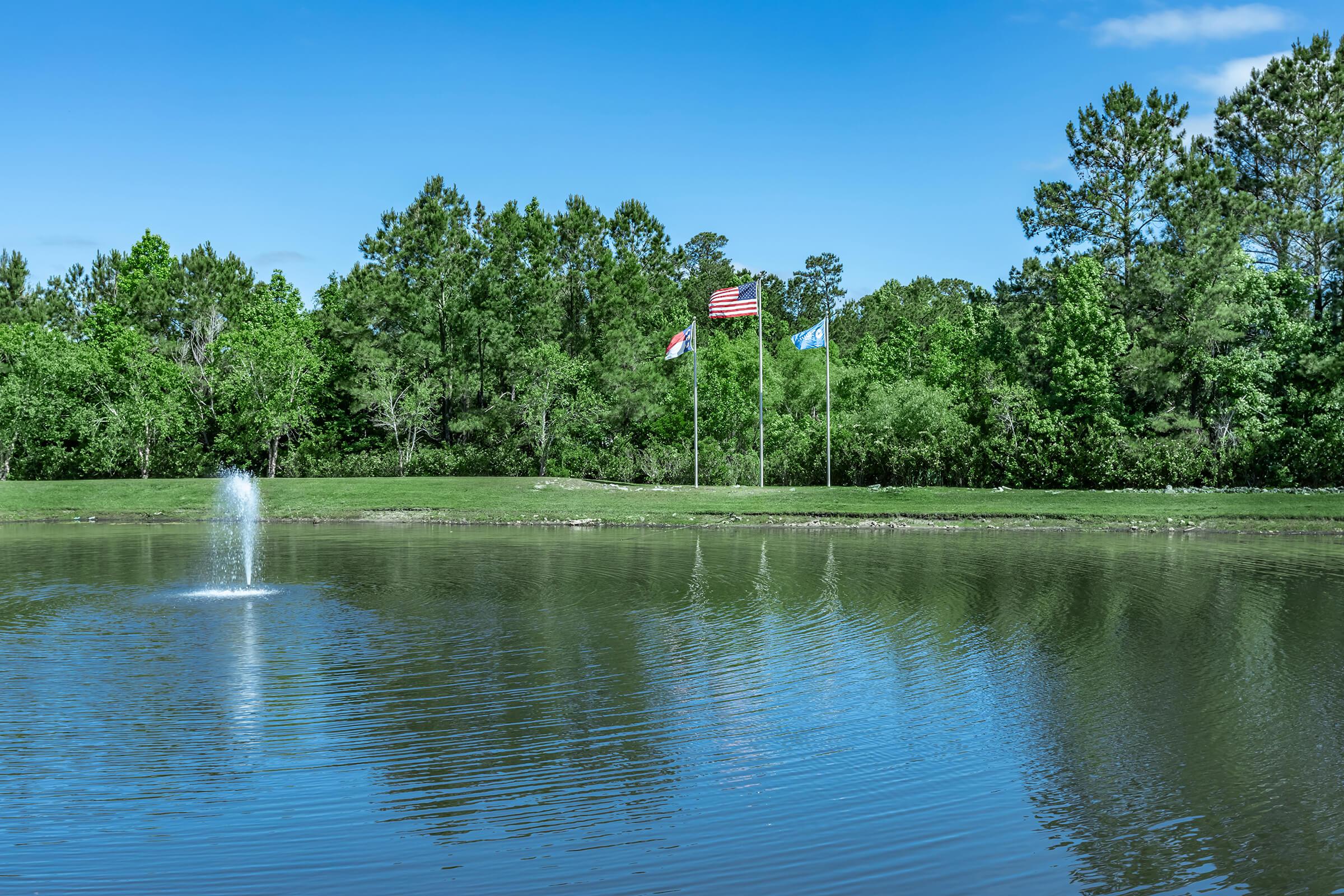 a pond next to a body of water